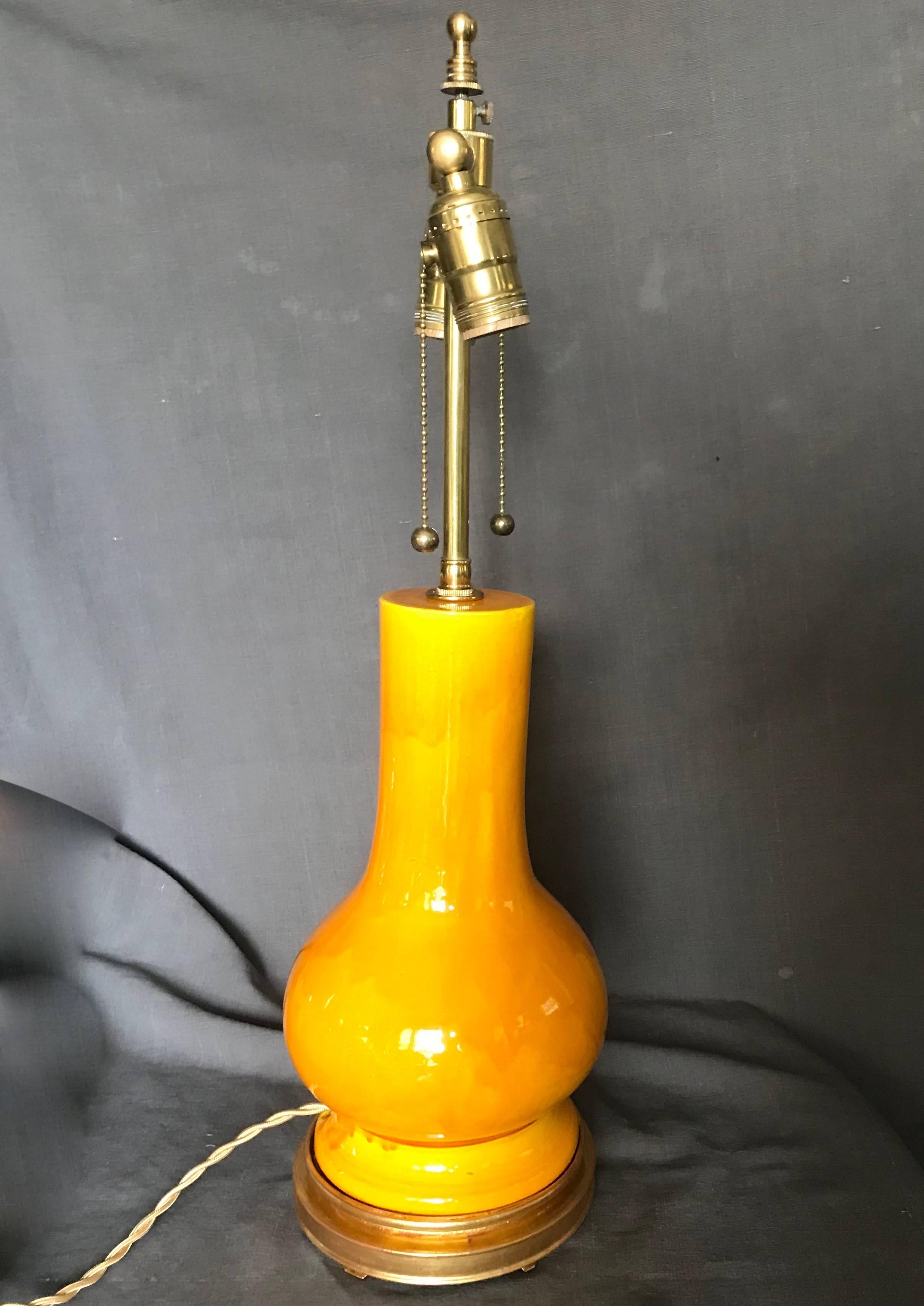 Vintage chrome yellow Japanese lamp on water gilt base. Vibrant yellow wash pottery lamp on newly gilt original thirties wood base; newly electrified with gold silk cord and switch. Japan, circa 1930
Dimensions: 6.5