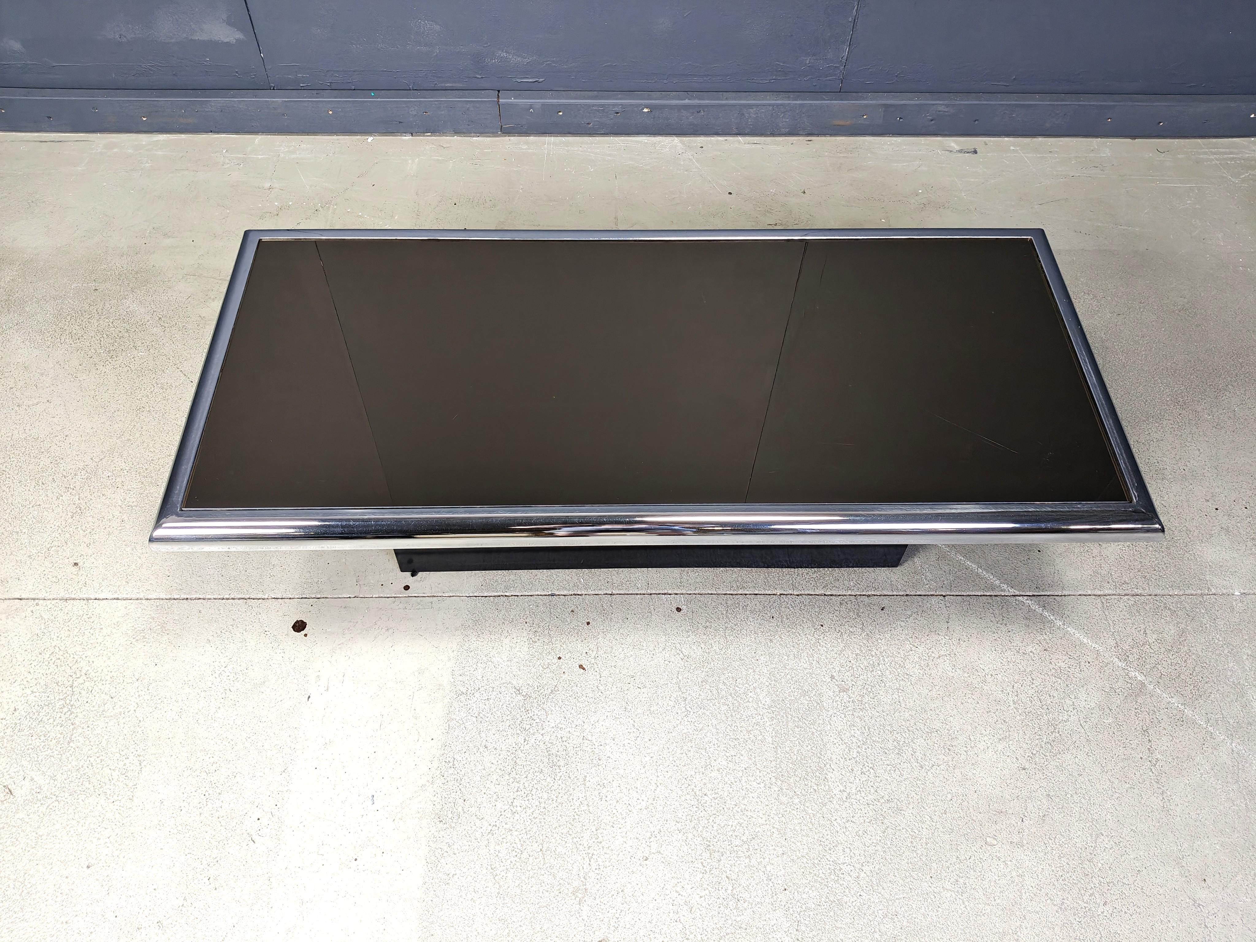 Seventies chromed metal and black glass coffee table on a black wooden base.

Timeless seventies design piece.

1970s - Italy

Dimensions:
Height: 40cm
Width: 130cm
Depth: 60cm

Ref.: 25071813

*All images are always part of the description, our