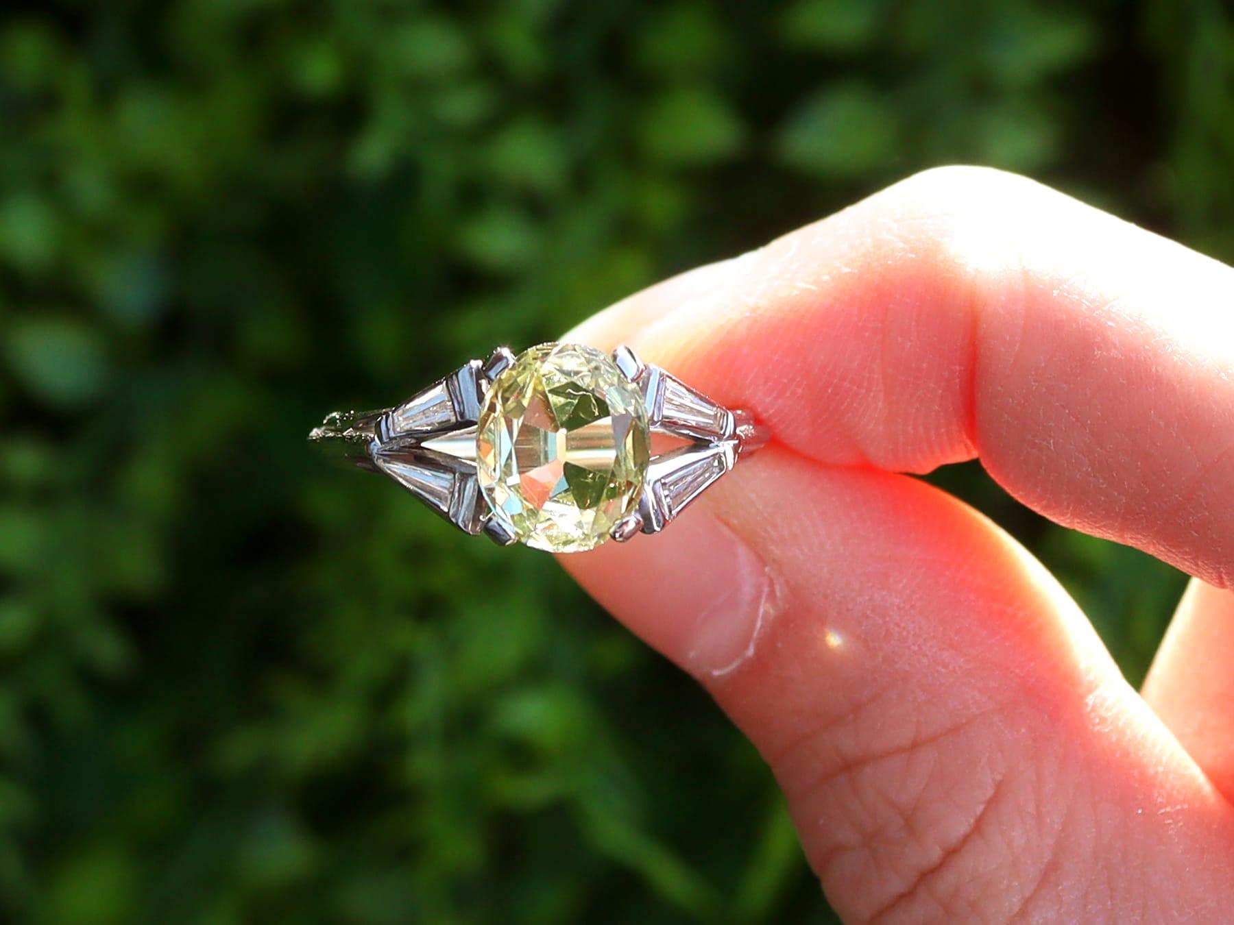 This stunning, fine and impressive vintage 1960s ring has been crafted in 18k white gold.

The impressive pierced decorated setting displays a central feature four-claw set 2.16ct oval faceted cut chrysoberyl.

The bifurcating ring shoulders