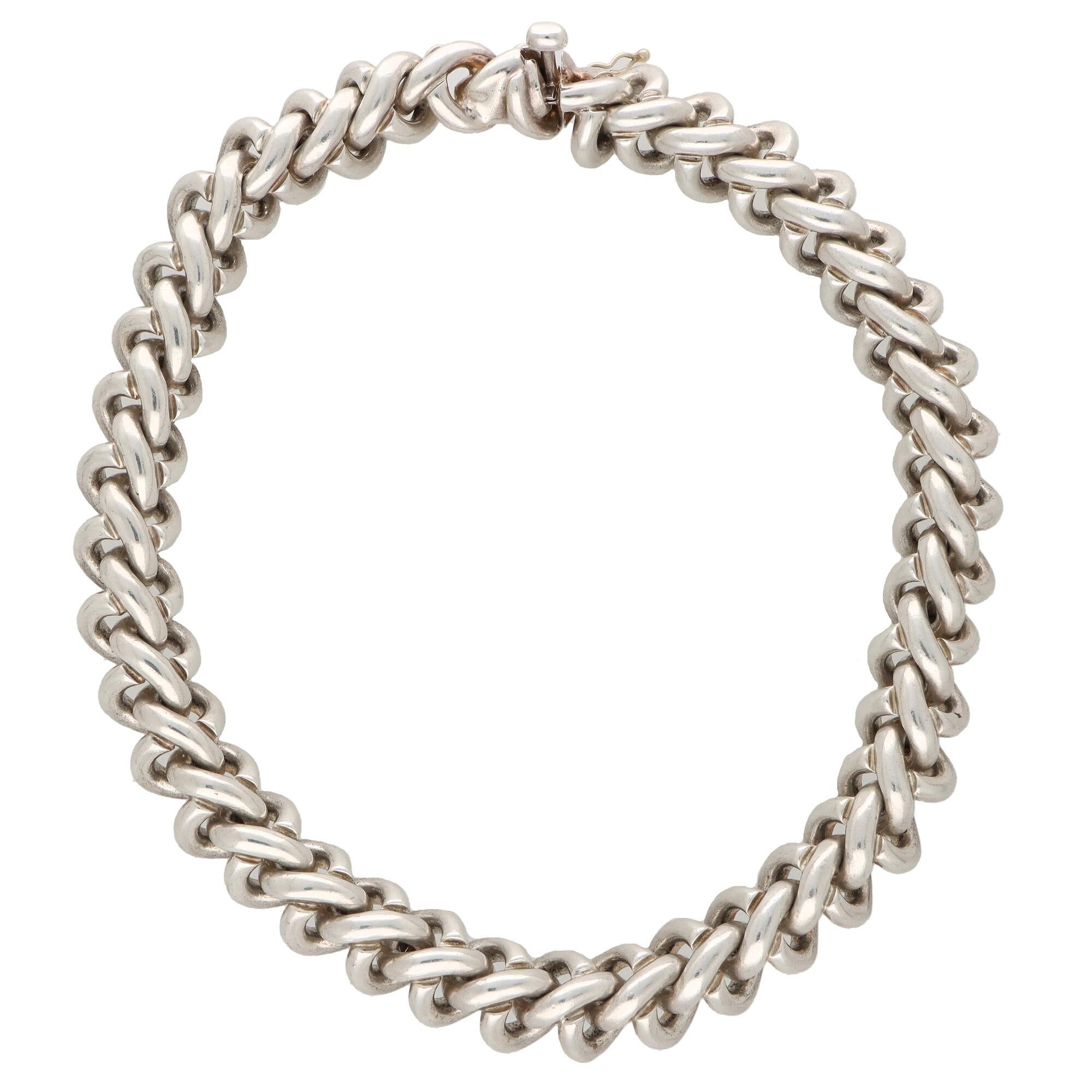 A rather interesting vintage chunky choker chain necklace set in solid silver. 

The necklace is composed of 38 solid silver links and sits beautifully once on the neck. Due to the design of the necklace it could easily be worn by itself as a