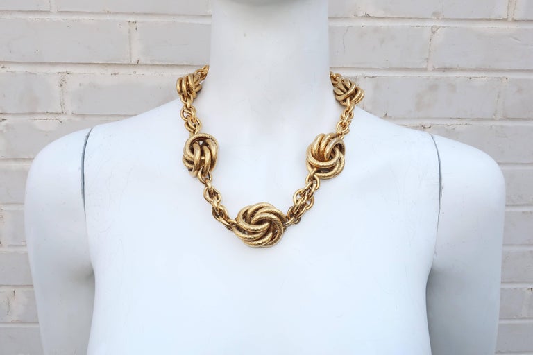 Get the Midas touch with this vintage gold tone chunky chain necklace.  The heavy gold link chain is accented with graduated knots formed from braided rings.  The detail and quality gives the appearance of fine jewelry to ultimate statement-making