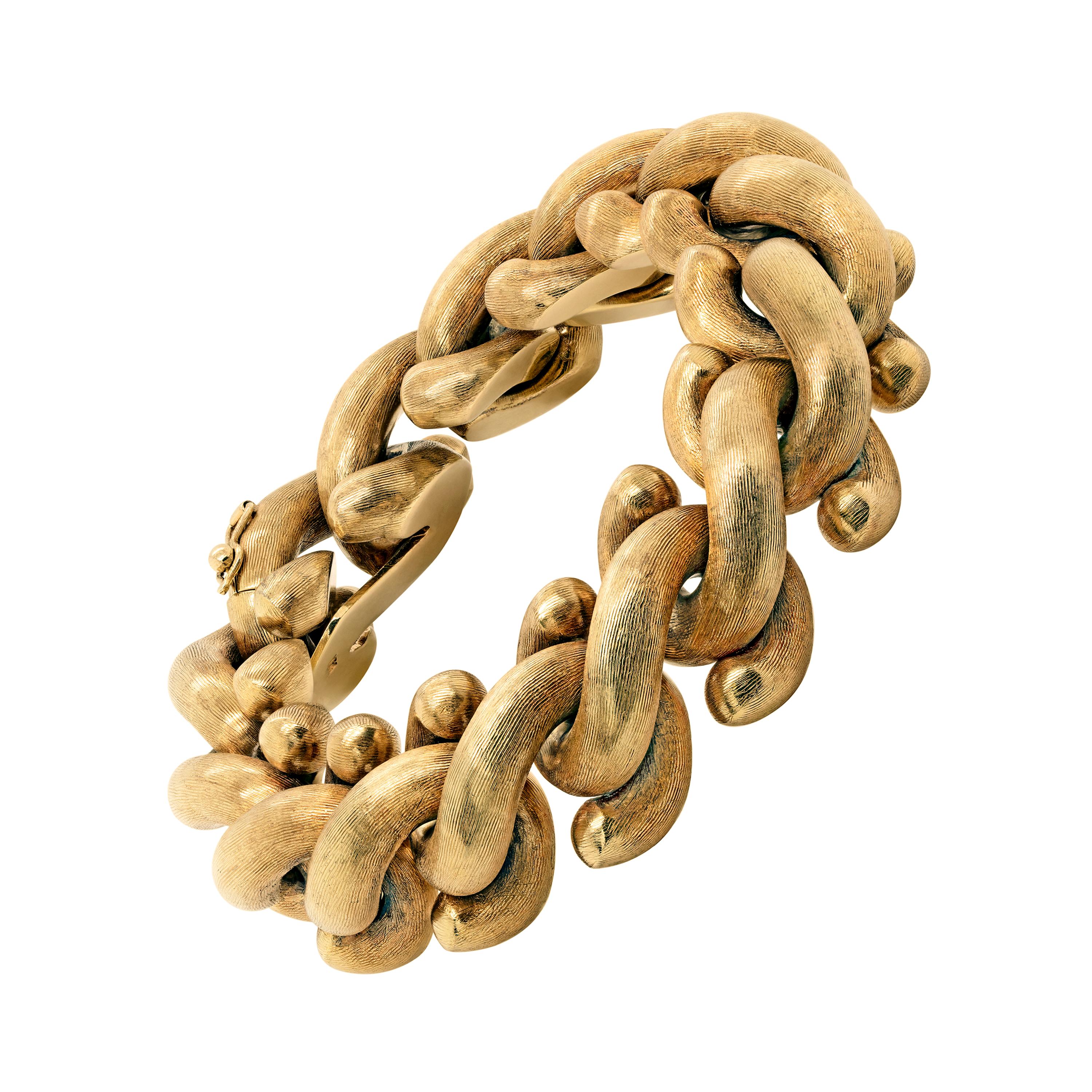 This stunning bracelet is crafted in 14 carat yellow gold, designed with fancy intertwined hook links hand finished with an etched texture giving the bracelet a beautiful sheen in movement. The piece measures 8.5 inches in length and weighs 73.11