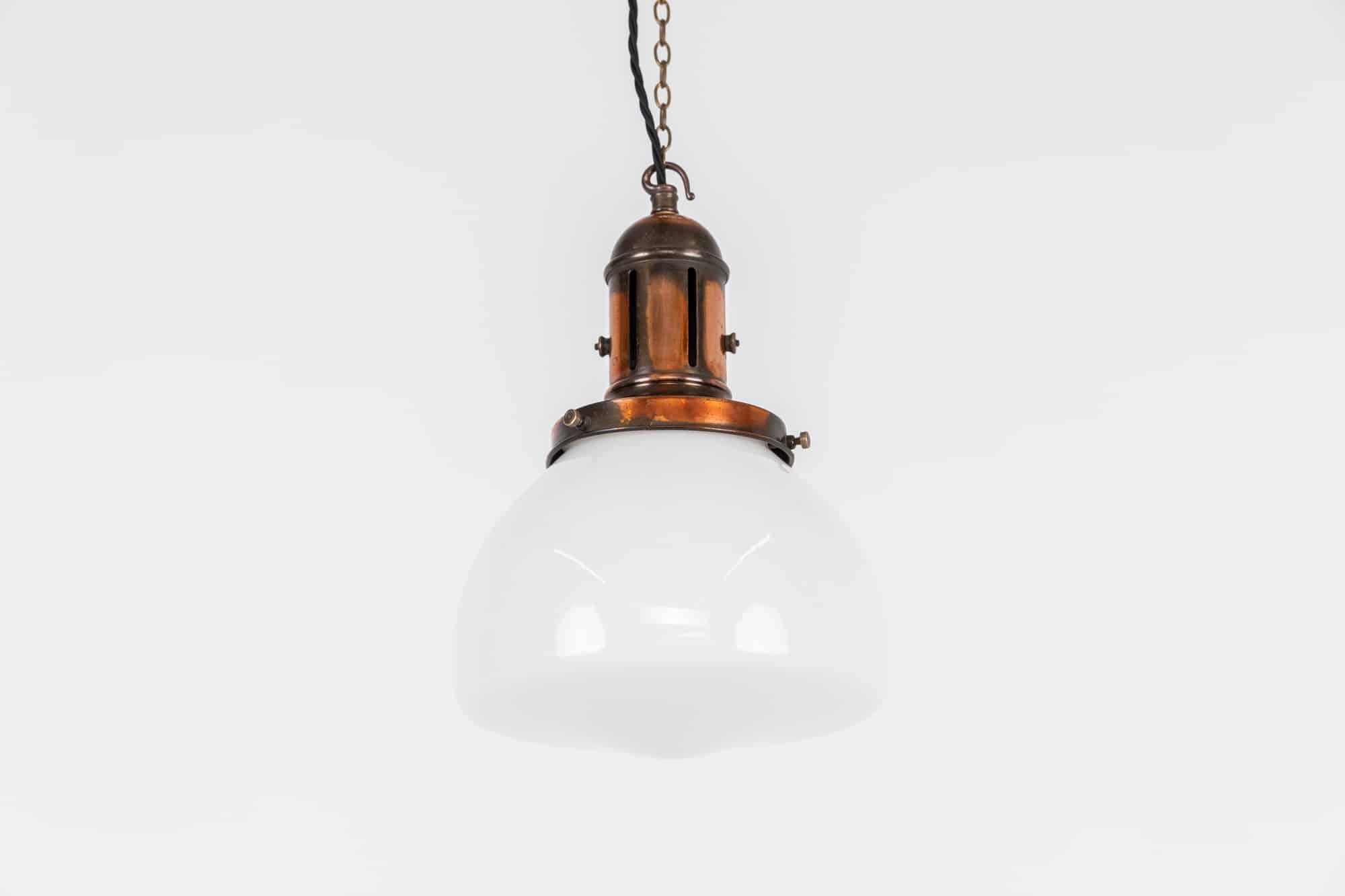 

An elegantly shaped church opaline glass lamp with copper gallery made by Benjamin Electric. c.1930

Of rounded form, heavy duty opaline glass and complementing shaped copper gallery.

Rewired with 1m of black twisted flex.
