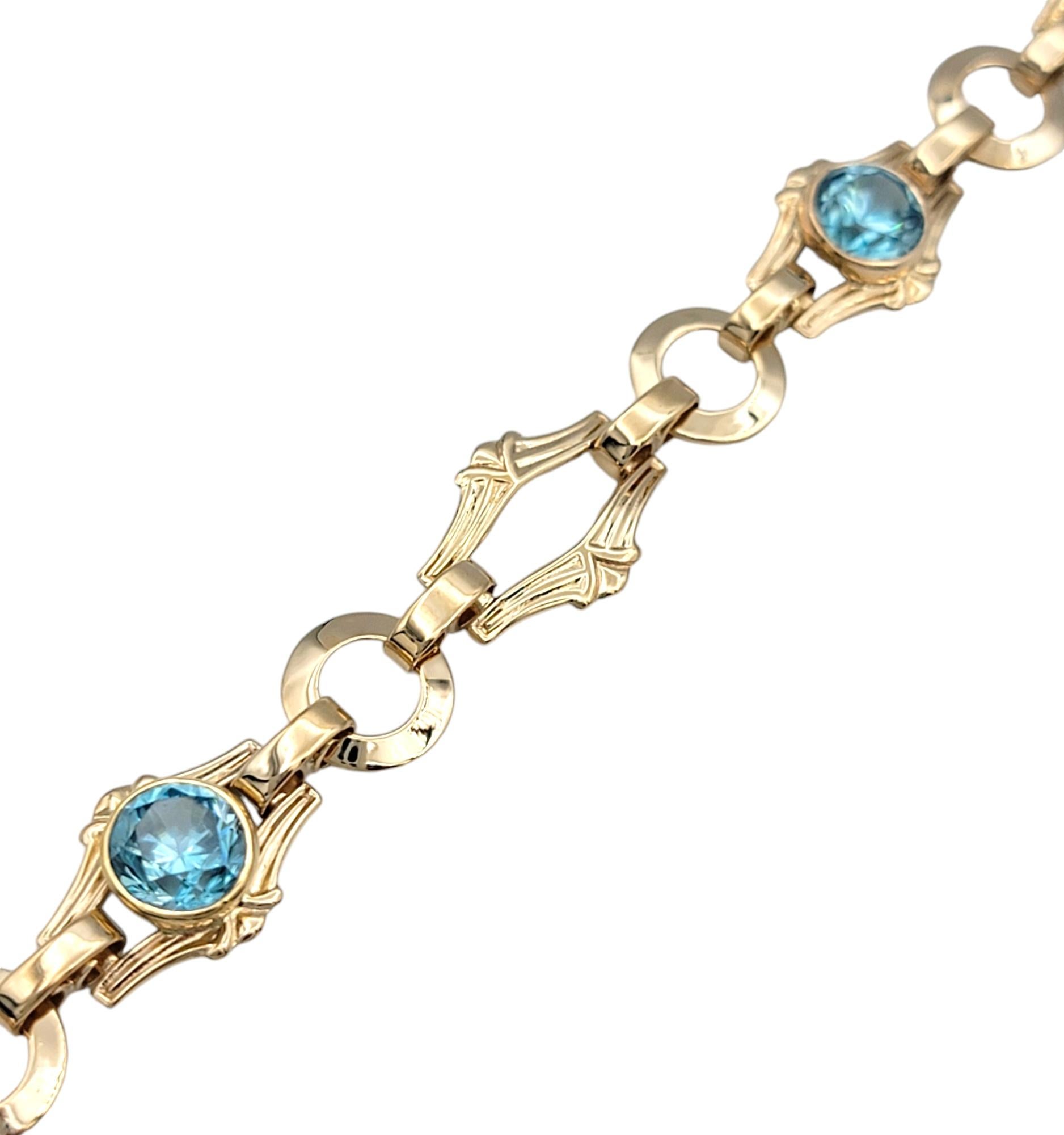 Embrace the essence of vintage luxury with this exquisite bracelet by Church & Company, a stunning display of craftsmanship and elegance. The ornate design features intricately detailed links that connect three breathtaking round blue zircons, each