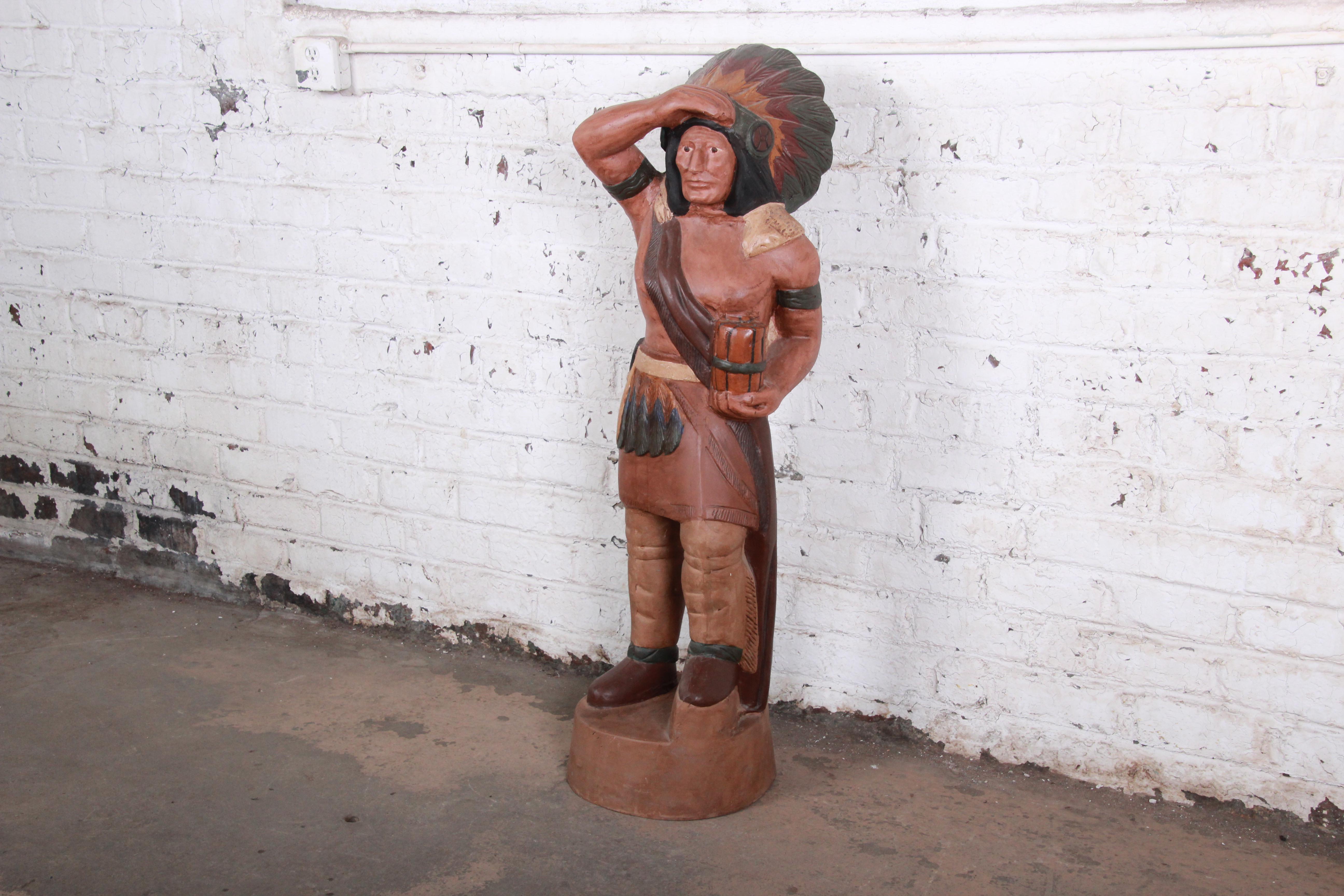An iconic cigar store Indian statue, featuring an Indian chief in traditional headdress. Wonderfully painted in detail over cast metal. The statue is heavy and sturdy. It is in excellent original vintage condition.

Measures: 15