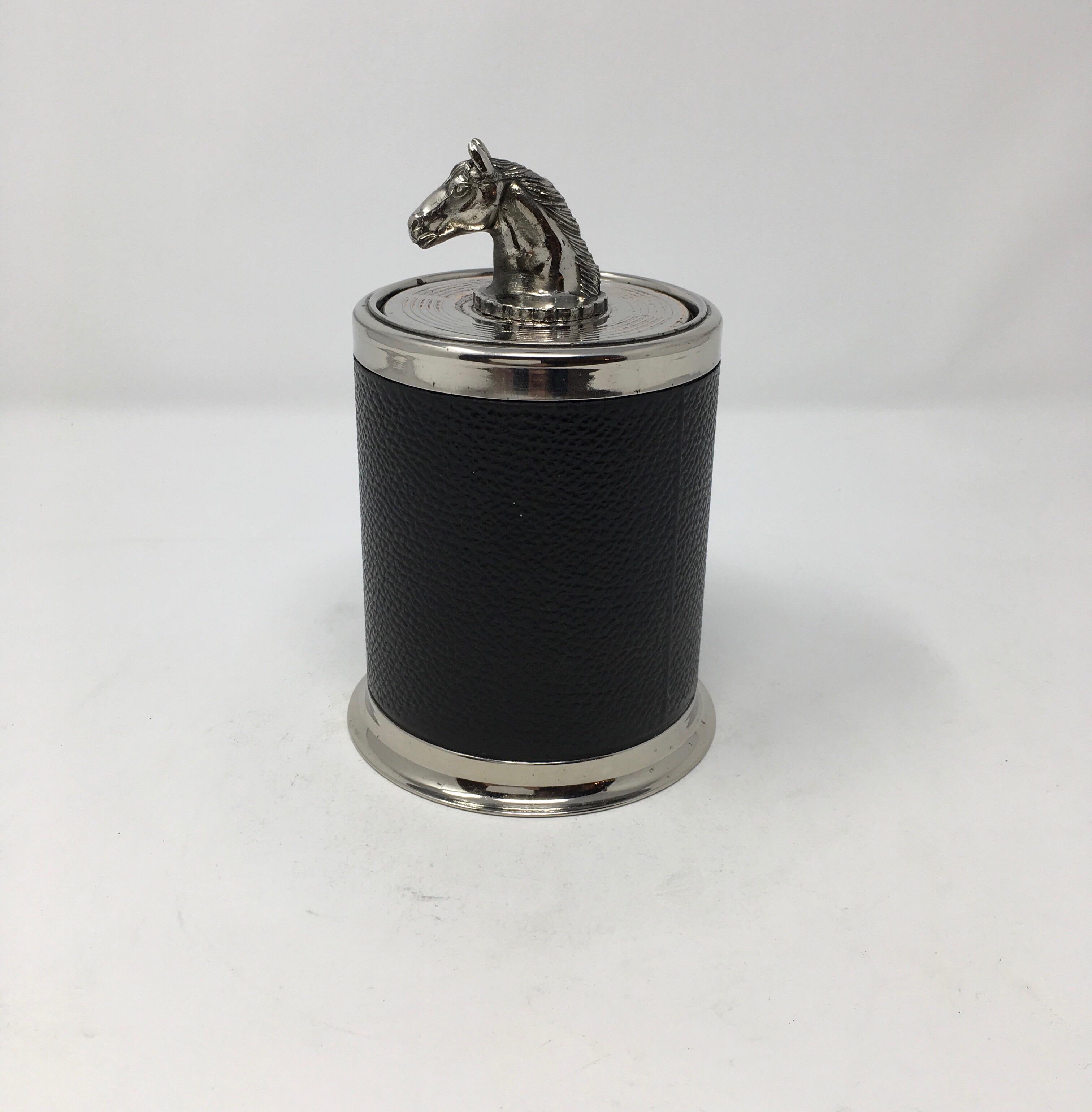 This is a leather and chrome pop up cigarette holder. A perfect accessory for the smoker or horse lover. The piece opens by pulling the horse head up and has space to store 18 cigarettes inside. In very nice original condition.