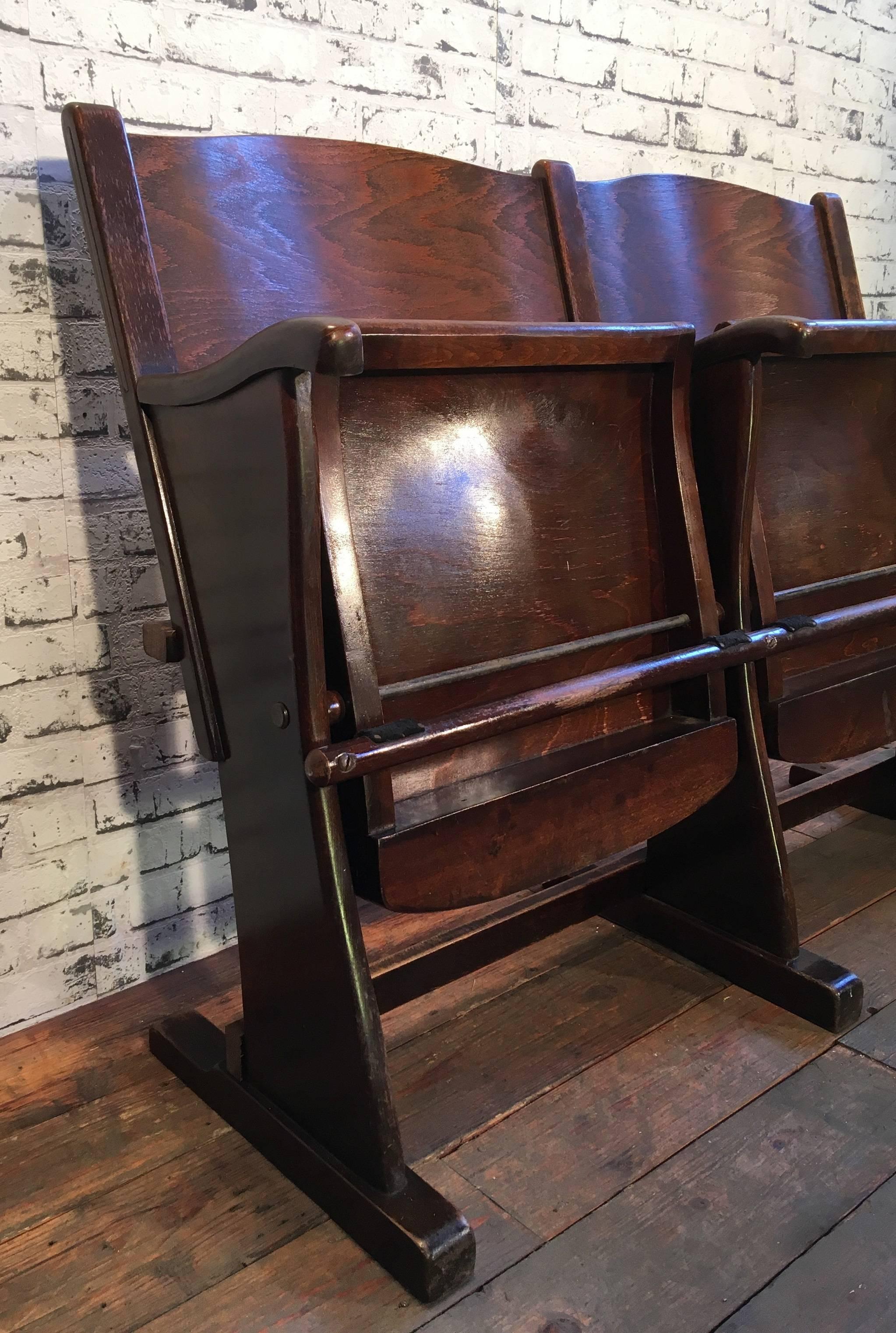 This two-seat cinema bench was produced  in former Czechoslovakia during the 1950s. The chairs are stable and can be placed anywhere. It is completely made of wood (partly solid wood, partly plywood). The seats fold upwards. The weight of the bench