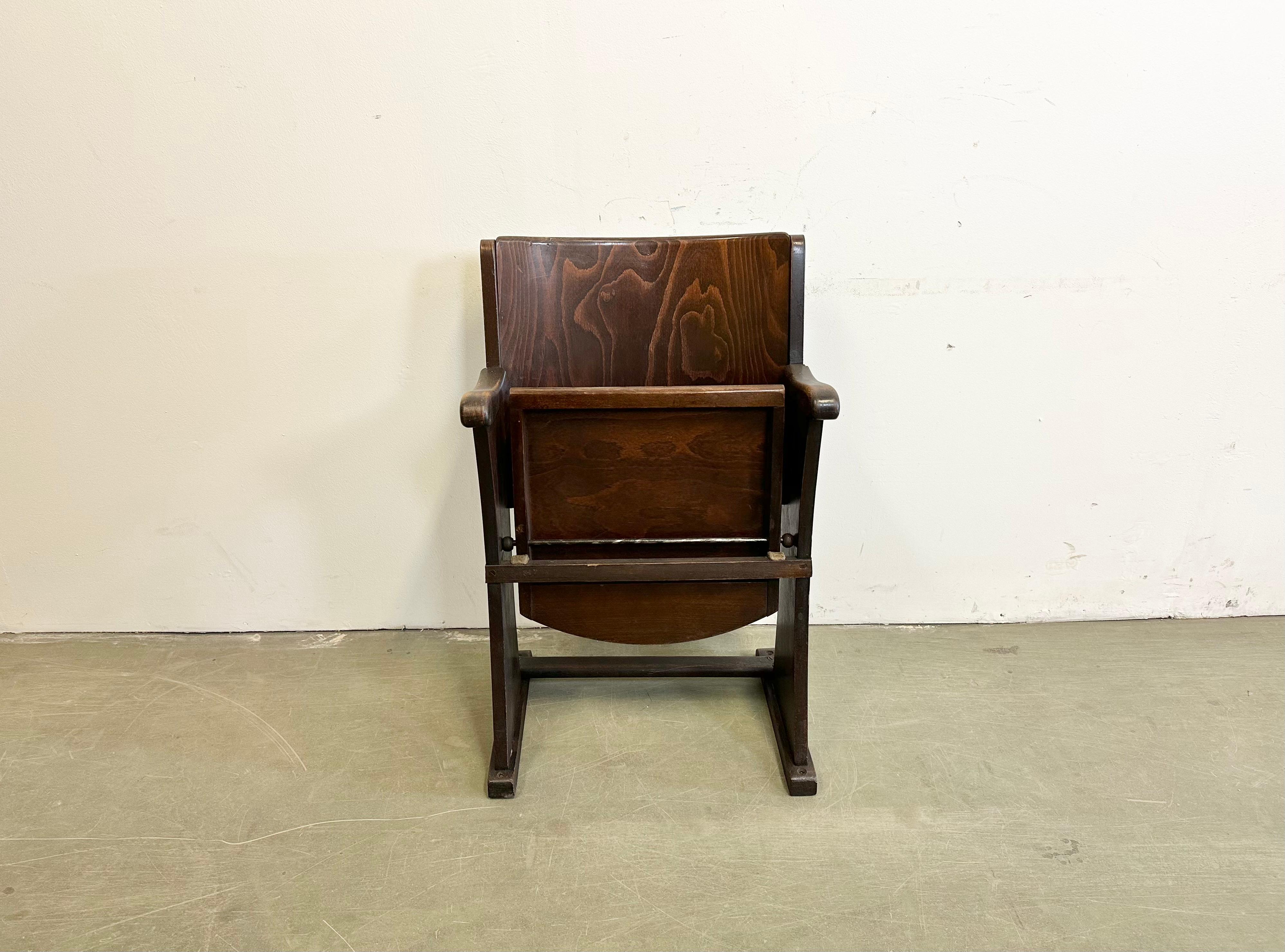 This folding cinema chair was produced by Thonet in former Czechoslovakia during the 1930s-1950s. The chair is stable and can be placed anywhere. It is completely made of wood (partly solid wood, partly plywood). The seat fold upwards. The weight of