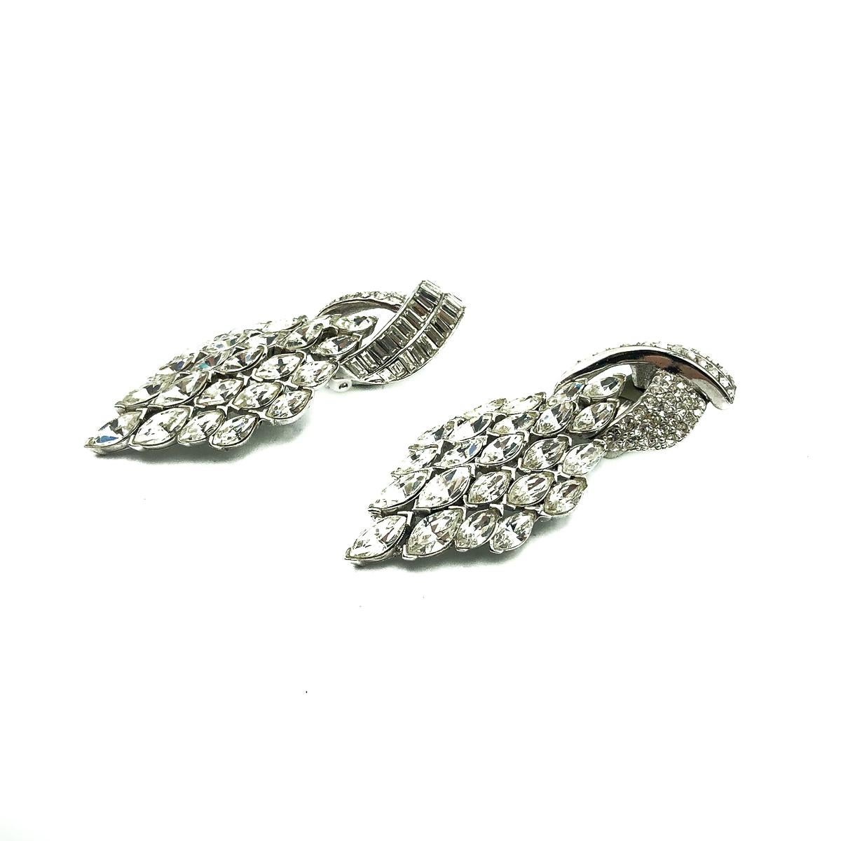 Vintage Ciner Deco Earrings. A captivating pair of Vintage Ciner Art Deco Cocktail Earrings from the 1980s. Adorable, timeless art deco revival earrings encrusted with wall to wall shimmering rhinestones. Crafted in rhodium plated metal. Clip