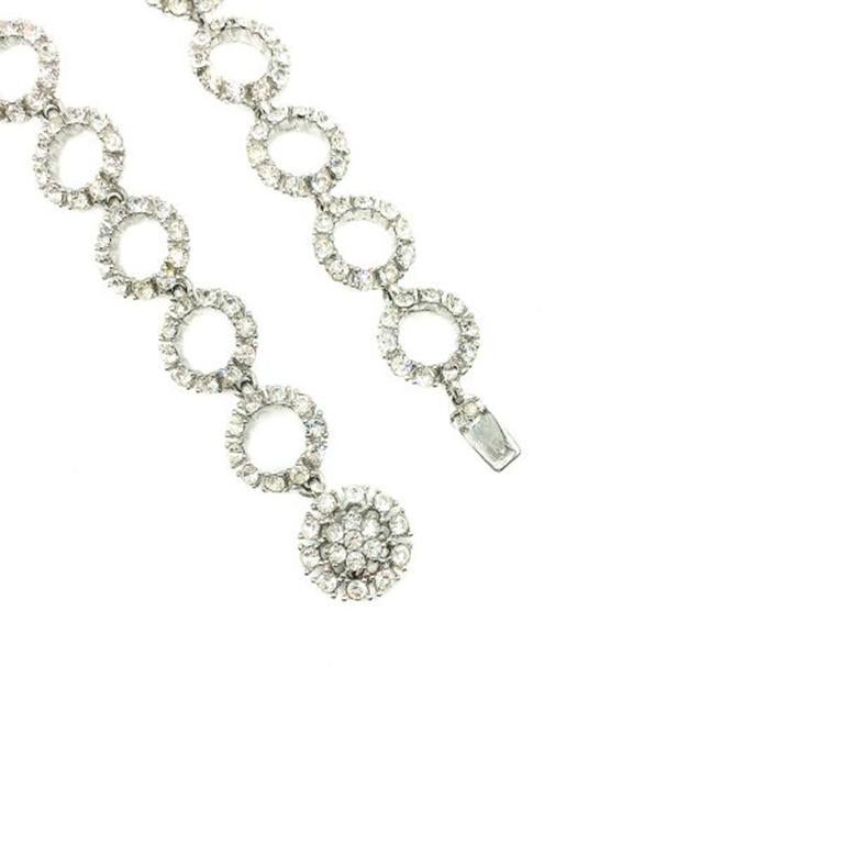 A Vintage Ciner Deco Necklace. Art Deco in design with its circle motifs linked together to create a wonderful long and very glamorous necklace. Crafted in rhodium plated metal set with chaton crystal stones. In very good vintage condition, cms,