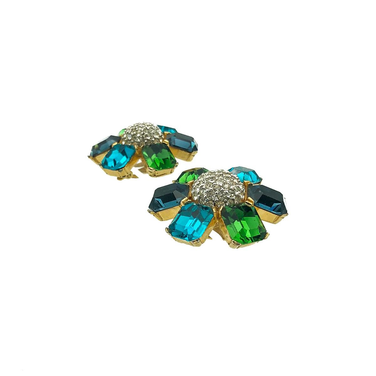 Vintage Ciner Flower Earrings. Crafted in gold plated metal and featuring a sumptuous display of large emerald cut crystals in dark green, deep blue and turquoise. Finished with a central dome of small pave set chatons. Very good vintage condition,