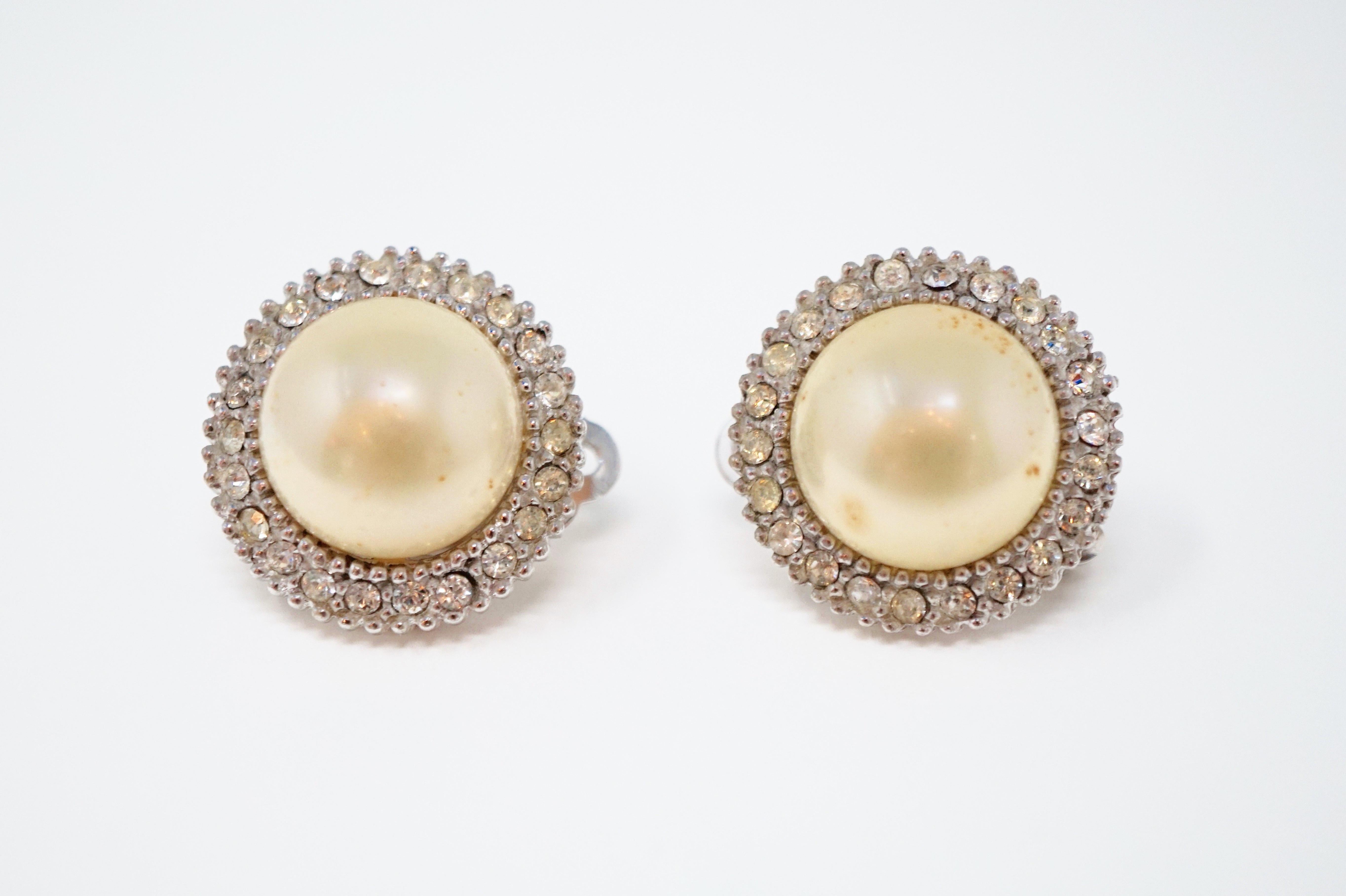 These gorgeous vintage faux pearl and crystal rhinestone pavé clip-on earrings by iconic costume jewelry brand, Ciner, are a perfect way to add a touch of elegance to your look.  Set against silver tone hardware, these earrings are perfect for