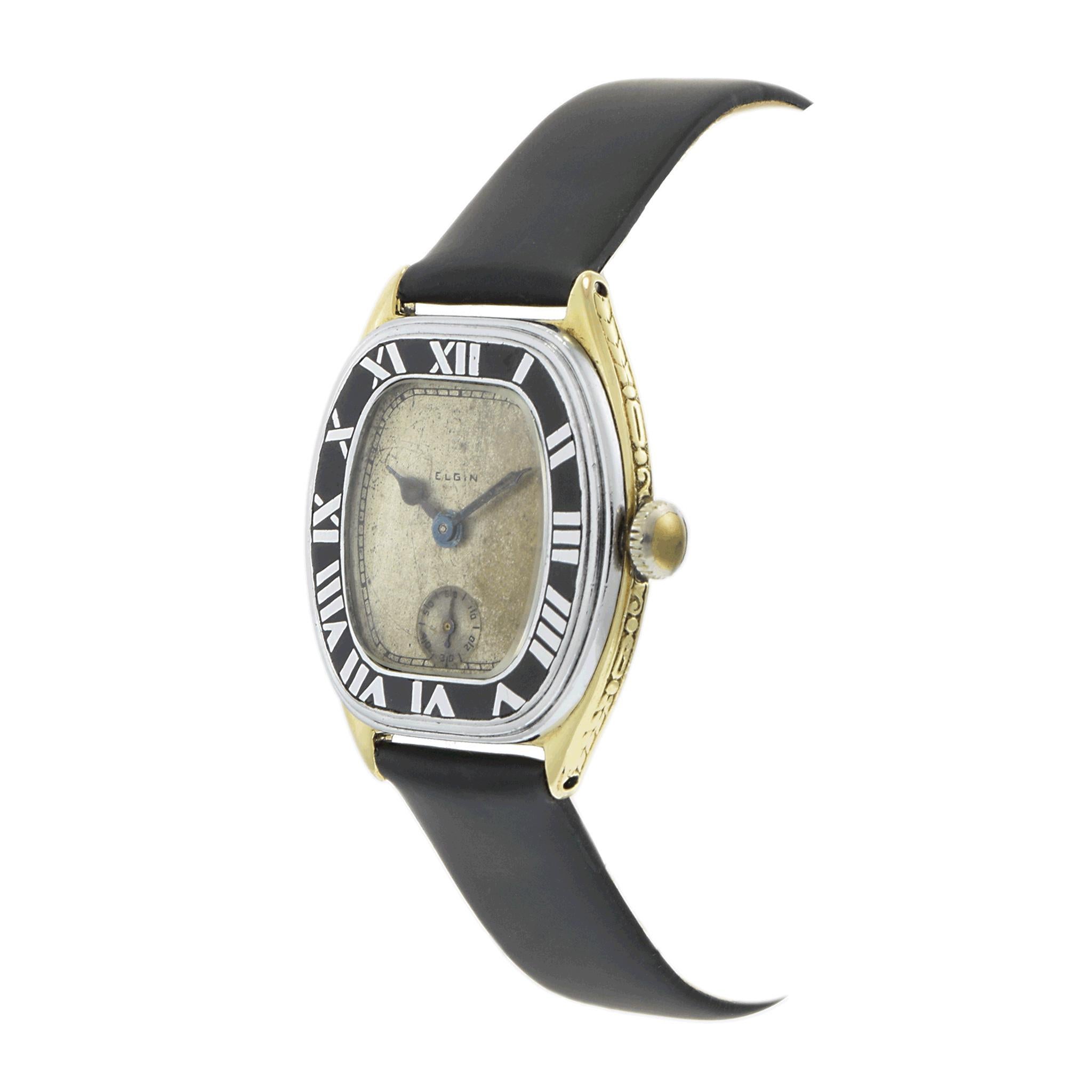 A stunning circa 1929 Elgin timepiece, showcasing the elegance of early 20th-century American watchmaking. The 29.5 x 30.5mm curved 14K yellow gold-filled case features intricate filigree detailing, paired with a nickel bezel for a refined Art Deco