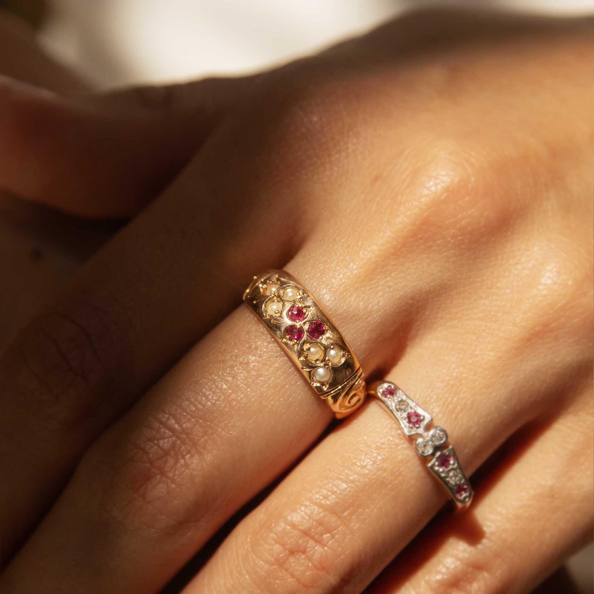 A vintage tapestry of rubies and seed pearls, our Katerina Ring is an exquisite gift from the 1930s. Her fiery rubies nestle amidst satiny pearls, their soft luster like the shimmering dew on a summers morning. Crafted in 18 carat yellow gold and