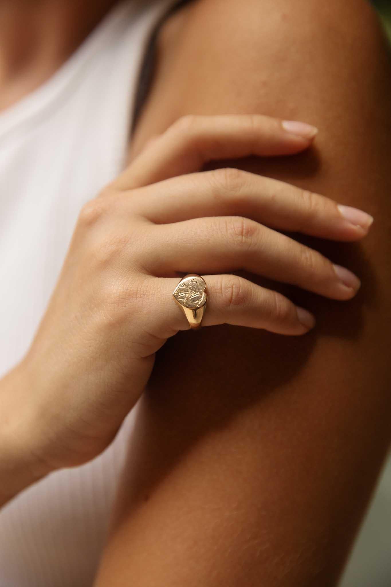 A heart-shaped signet, cast in 15 carat rose gold, hints at years of love and devotion. Intricate engravings dance across her surface, a secret language etched into eternity. Our Zayan Ring is a timeless token, a delicate balance of strength and