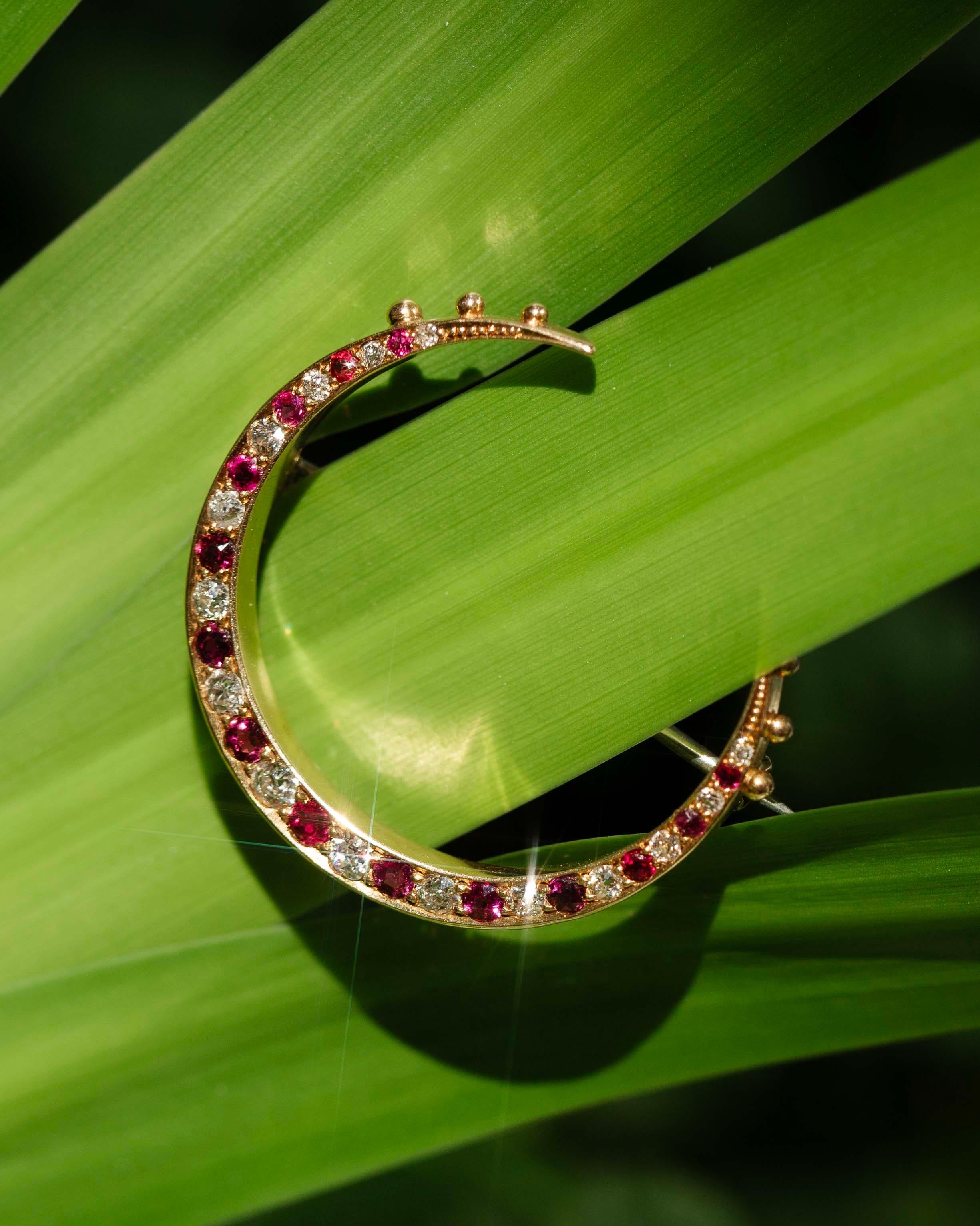 Our vintage Phoebe Brooch crafted with rubies and diamonds, like stars and moonlight, trace the curve of a crescent moon crafted in rich 18 carat gold. A celebration of beauty, she is a timeless piece, the perfect adornment for any occasion.

The