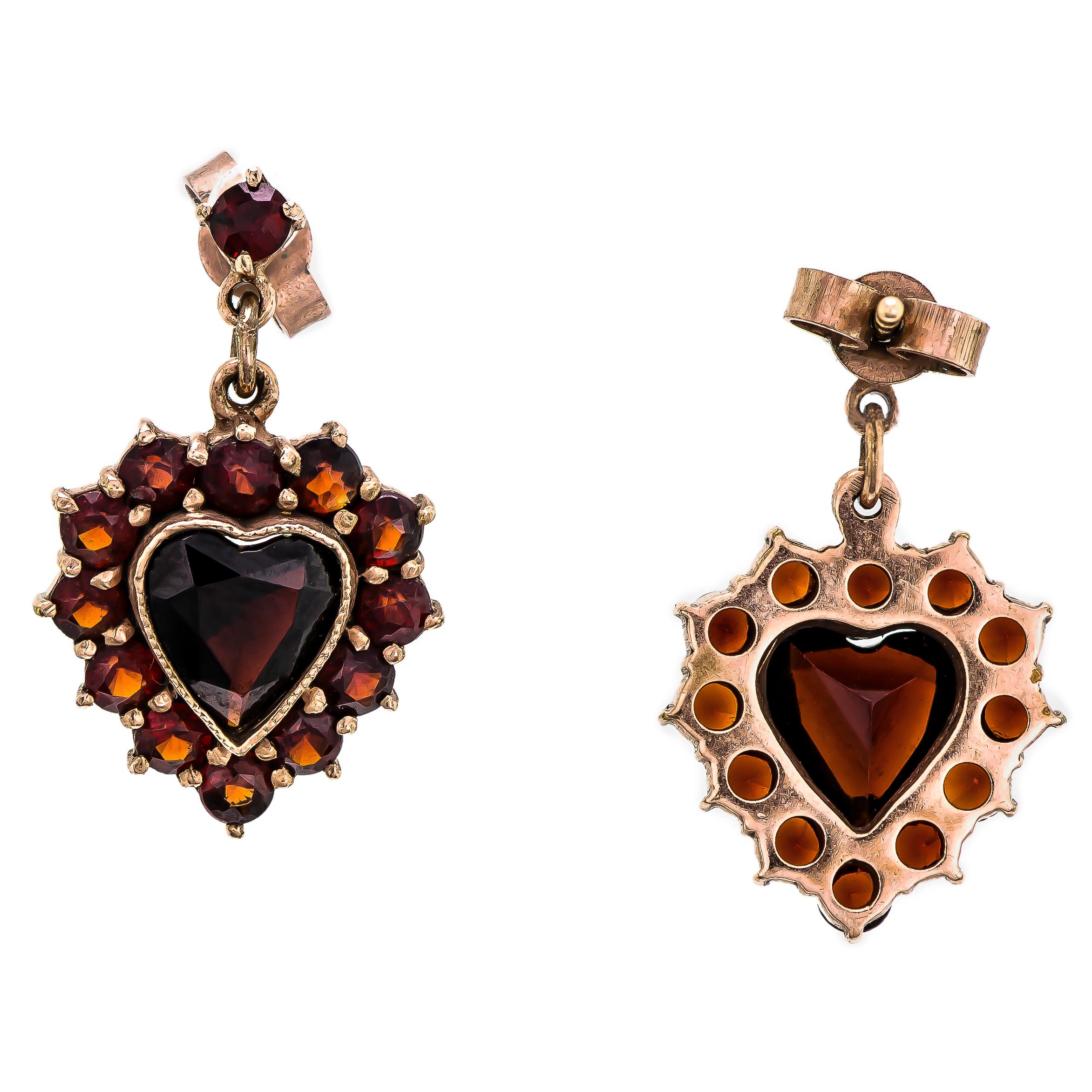 Lovely vintage circa 1940 garnet heart-shaped pendant drop earrings on 14k yellow gold posts set with one heart-shaped garnet and accented with numerous small round cut garnets.

Measurements: 
Approx. 7/8