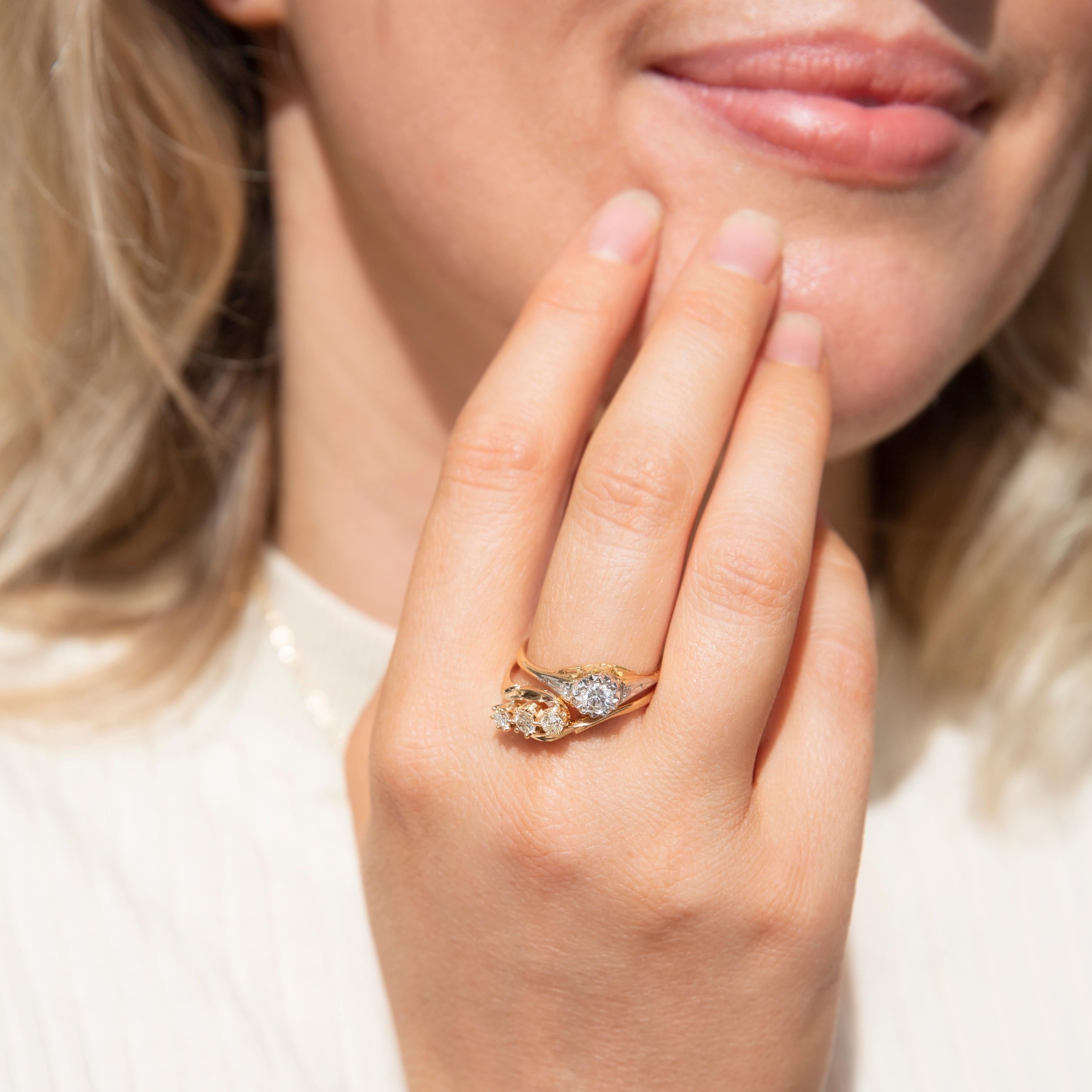 Crafted in 18 carat yellow gold, this lovely vintage ring, circa 1940s, features a shimmering trio of Old European Cut diamonds in a three-stone claw setting between swooping crossover shoulders. Her name is The Anyanka Ring. She imbues the wearer