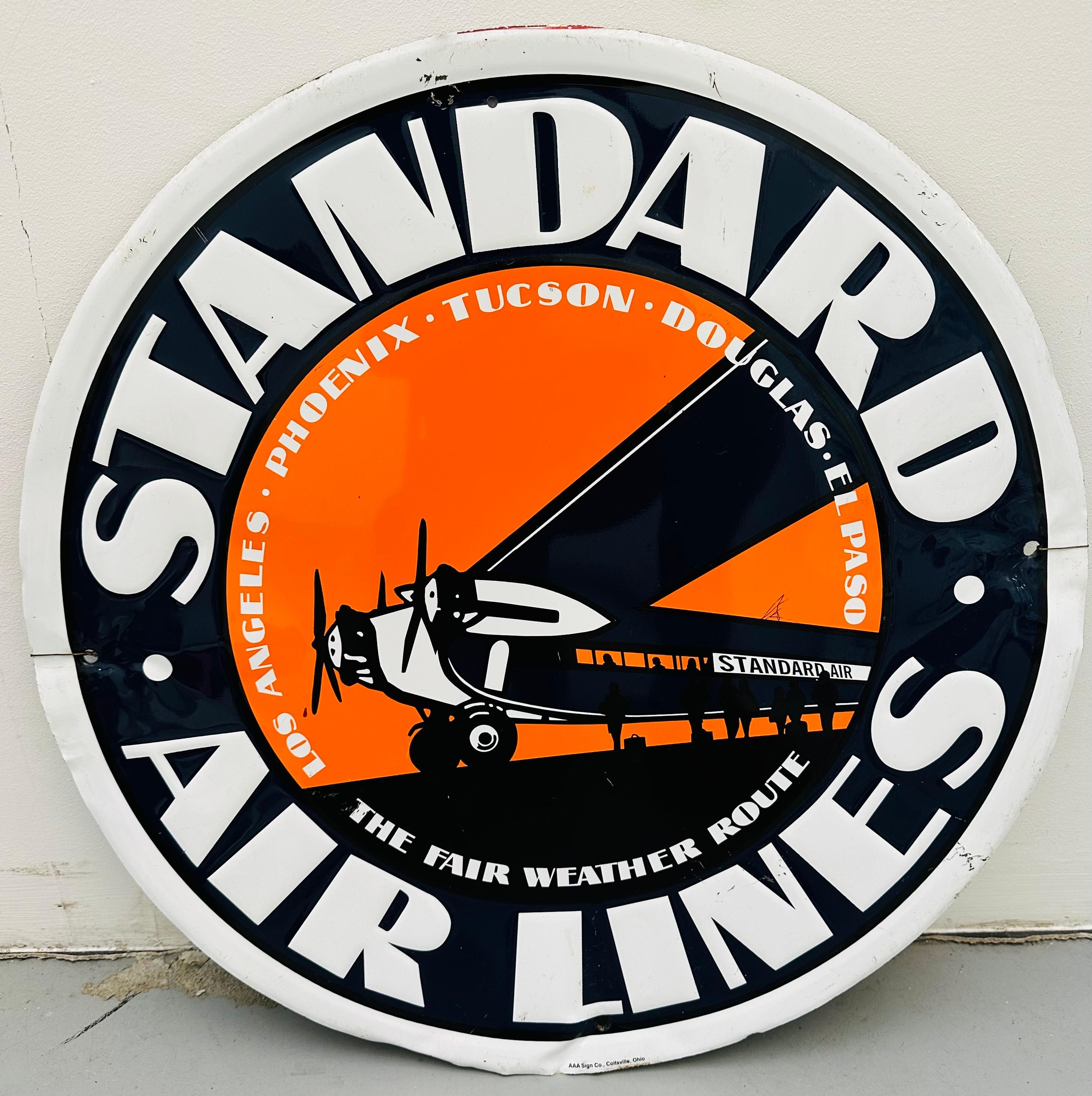 A vintage circa 1950s circular enamelled tin metal advertising sign for Standard Air Lines.  In worn vintage condition as illustrated in the images. In 1929 it merged with Western Air Express as Transcontinental & Western Air. I am making an