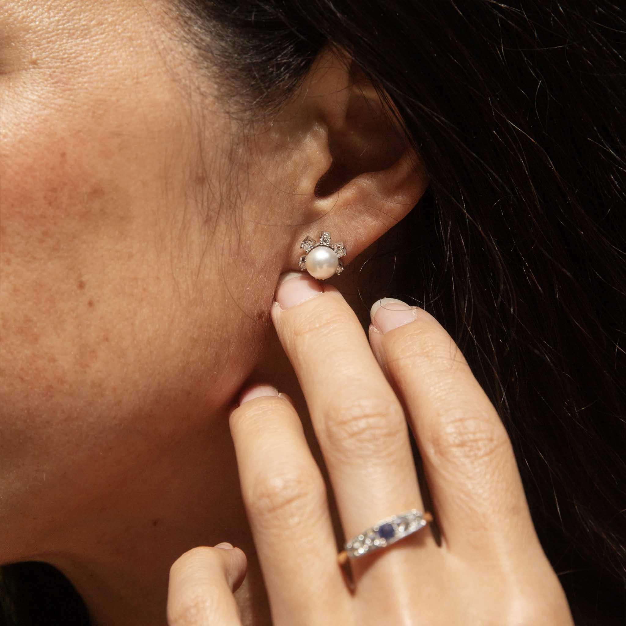 Like delicate blossoms kissed by morning dew, the Mattie Diamond and Pearl Studs offer a touch of timeless grace. With her lustrous pearls, cradled by sparkling diamonds in 14 carat white gold, she creates a captivating dance of light and texture.