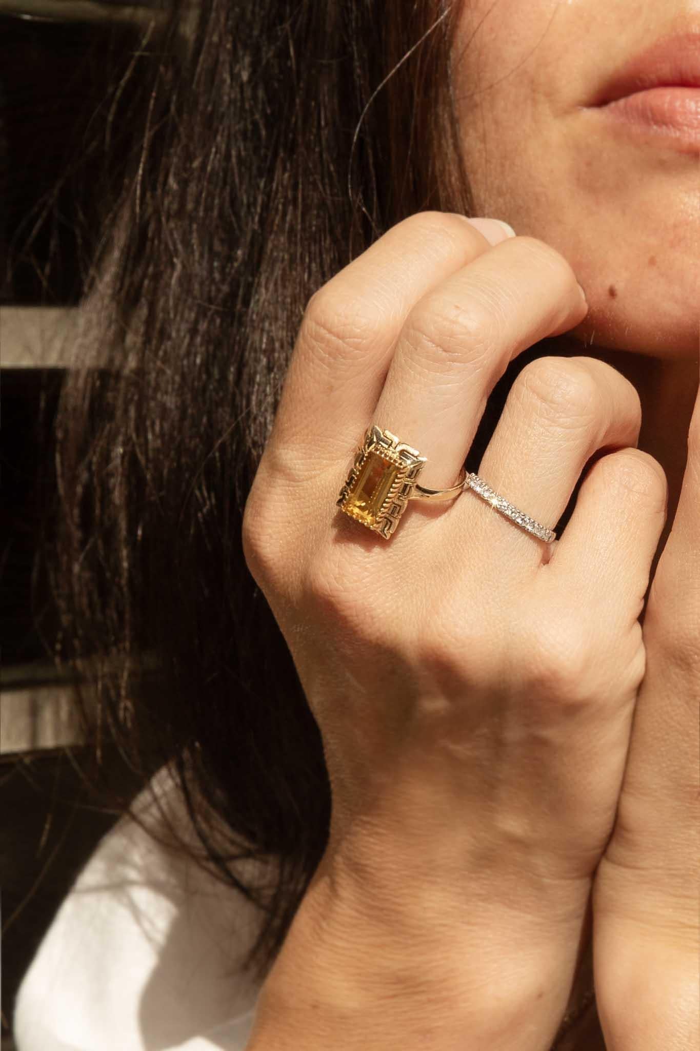 A sunlit gem, our Astoria Ring is a radiant jewel, a sunbeam captured in gold. Her elongated citrine, a vibrant splash of golden amber, is cradled in a geometric frame of 14 carat yellow gold. A design, reminiscent of ancient Greek motifs, is a