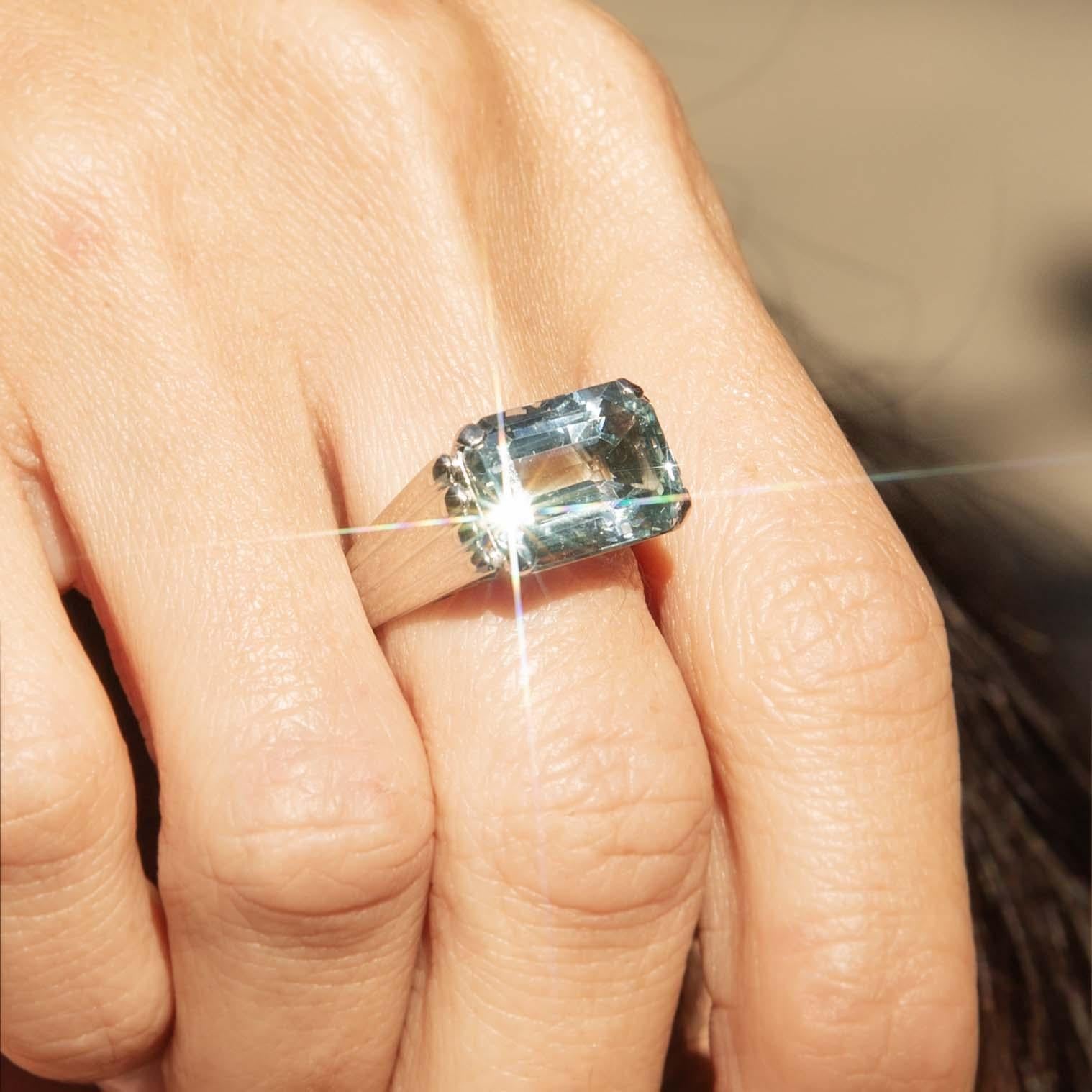 Discover the ethereal beauty of the Alizee Aquamarine Filigree Ring, an exquisite piece from a bygone era. Set in lustrous 18ct white gold, its emerald-cut aquamarine captures the light with every movement, evoking feelings of tranquillity. Perfect
