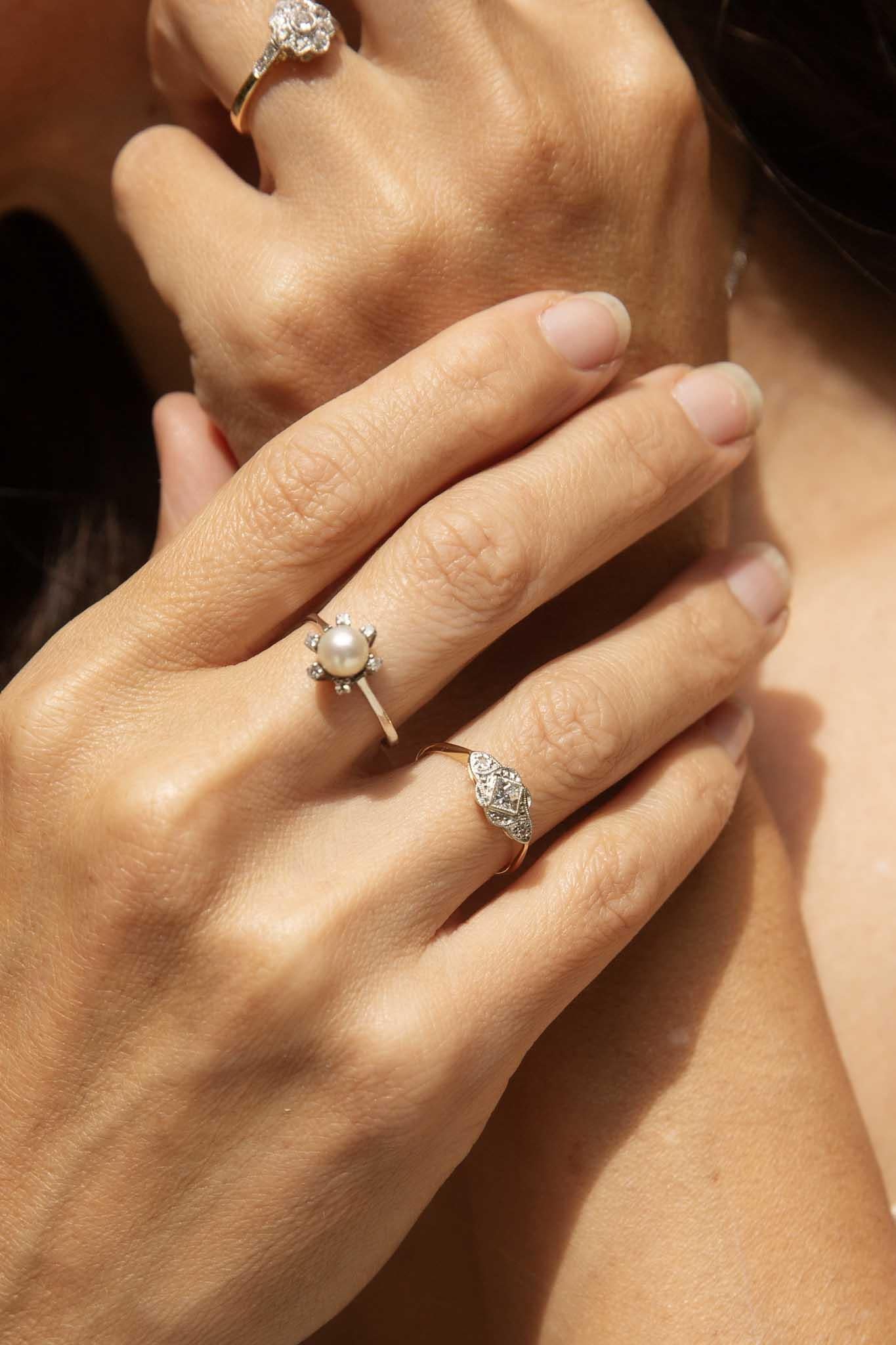 Our Dell Ring, crafted in platinum and 18 carat yellow gold, is adorned with a captivating central princess cut diamond, shining like a star in the night sky. Delicate smaller diamonds, like stardust, accentuate the sapphire's brilliance, creating a