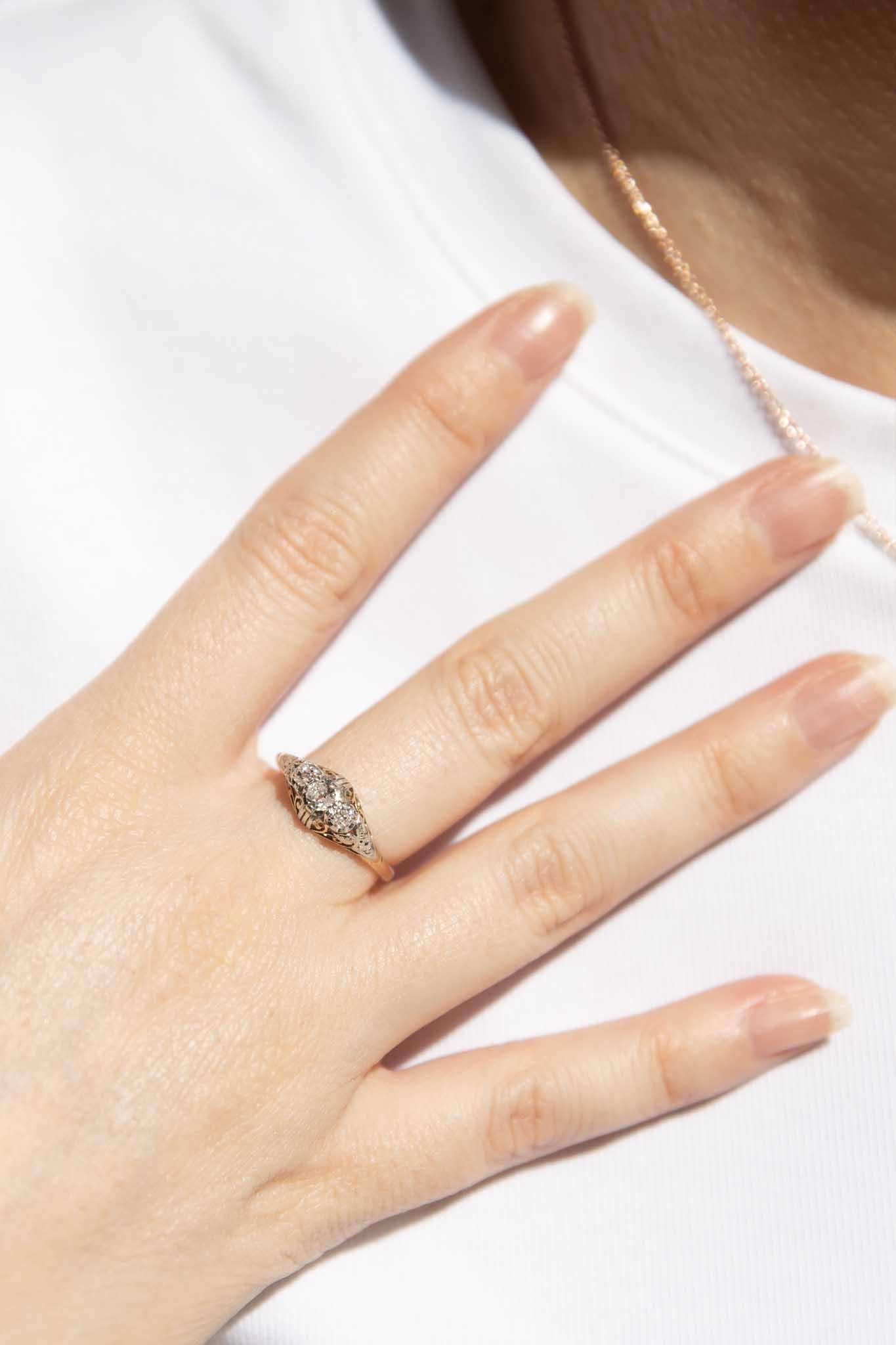 On a bridge of ribboning 18 carat gold embellished with sparkling diamond, our Pennie Ring is as though lace was spun with gold.  The sweetest of vintage treasures.

The Pennie Ring Gem Details
The three old cut diamonds are estimated to weigh 0.25