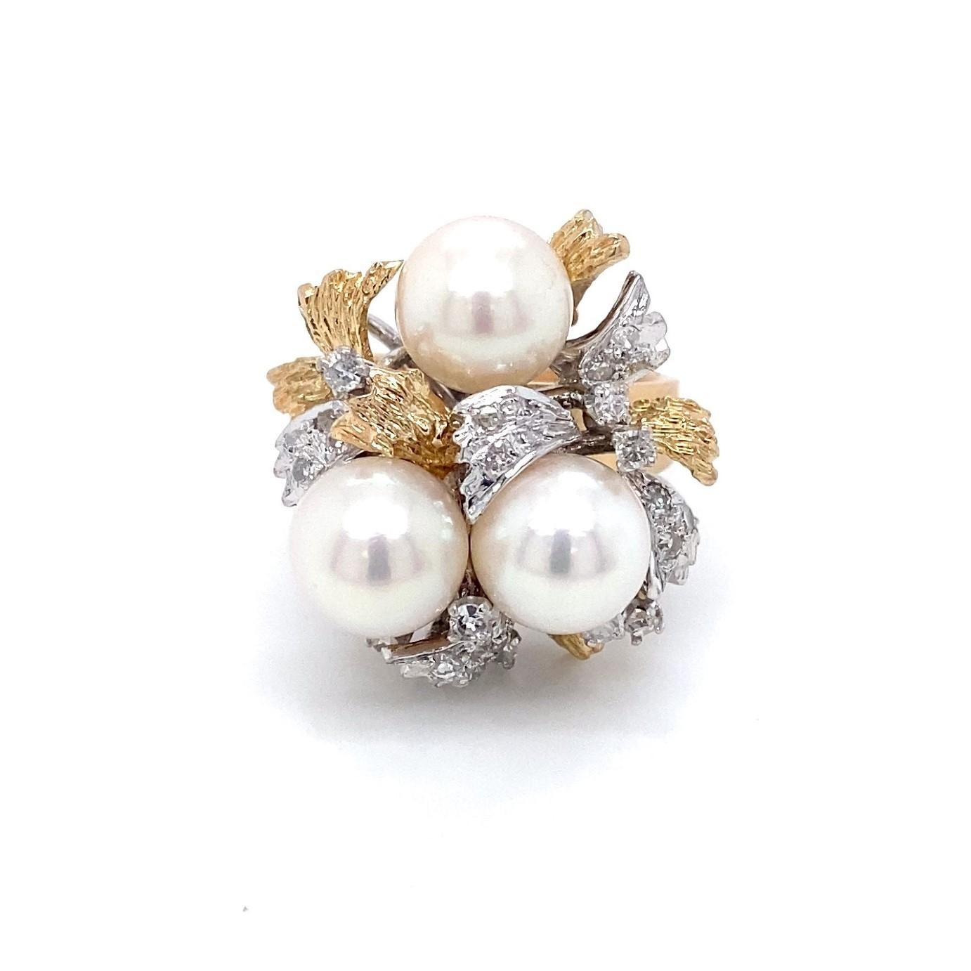 This big, bold zany but elegant circa 1960s cocktail ring is carefully constructed with an organic motif in solid 18 karat yellow and white gold.  The top of the ring is a separate construction from the base or shank and boasts three large