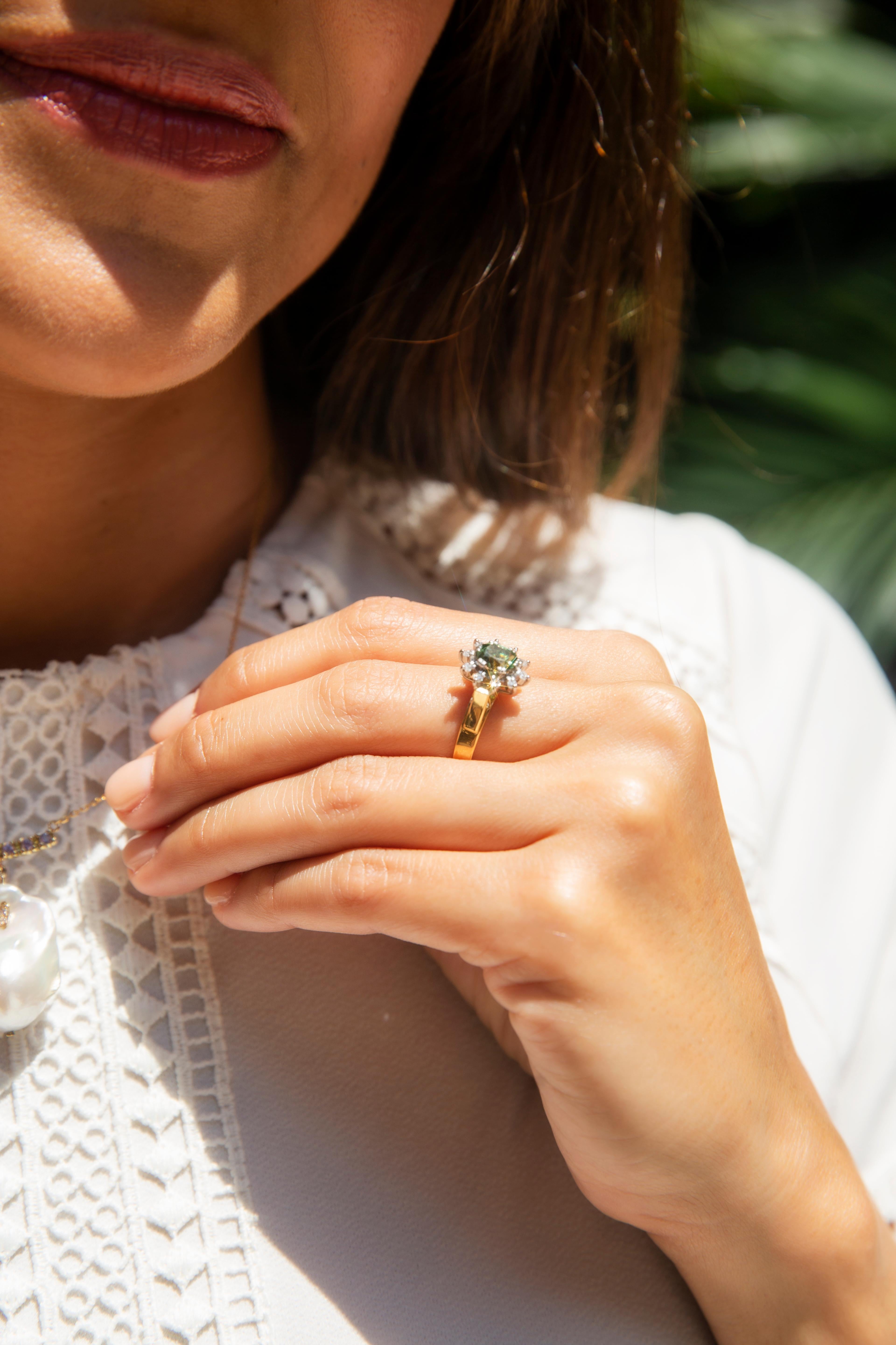 The Charlotte Ring, crafted in 18 carat gold, rises to lift a gorgeous green sapphire allowing the light to dance through and under. She is safe in the embrace of a halo of shimmering diamonds, a vintage delight to be celebrated.

The Charlotte Ring