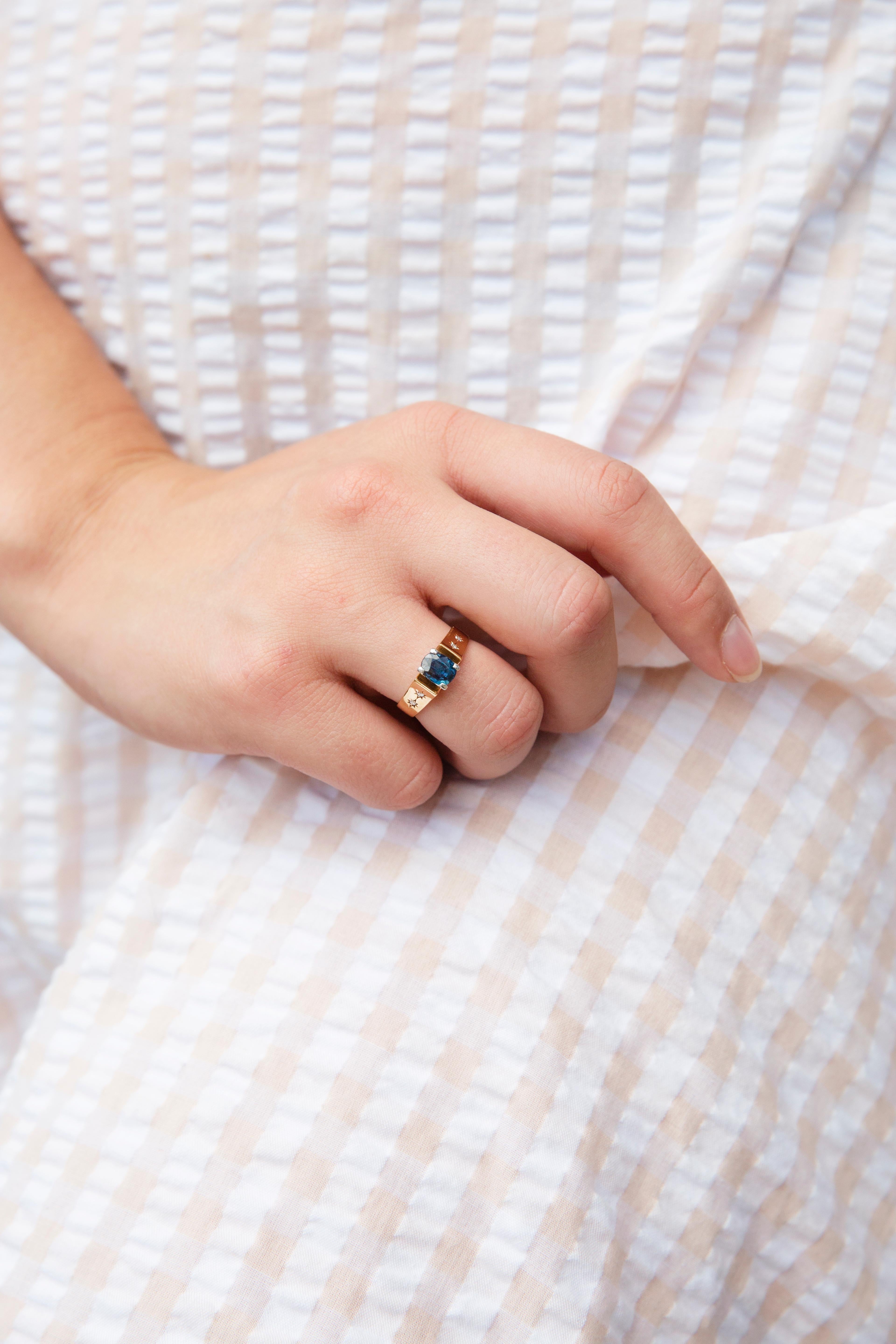 Forged in 18 carat gold, this fabulous vintage ring, circa 1970s, sees a yellow gold band holding a stunning 1.62 carat cushion-shaped deep greenish blue 