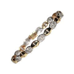 Bracciale decorato con diamanti naturali in oro 18 carati, vintage, anni 
70, circa.
