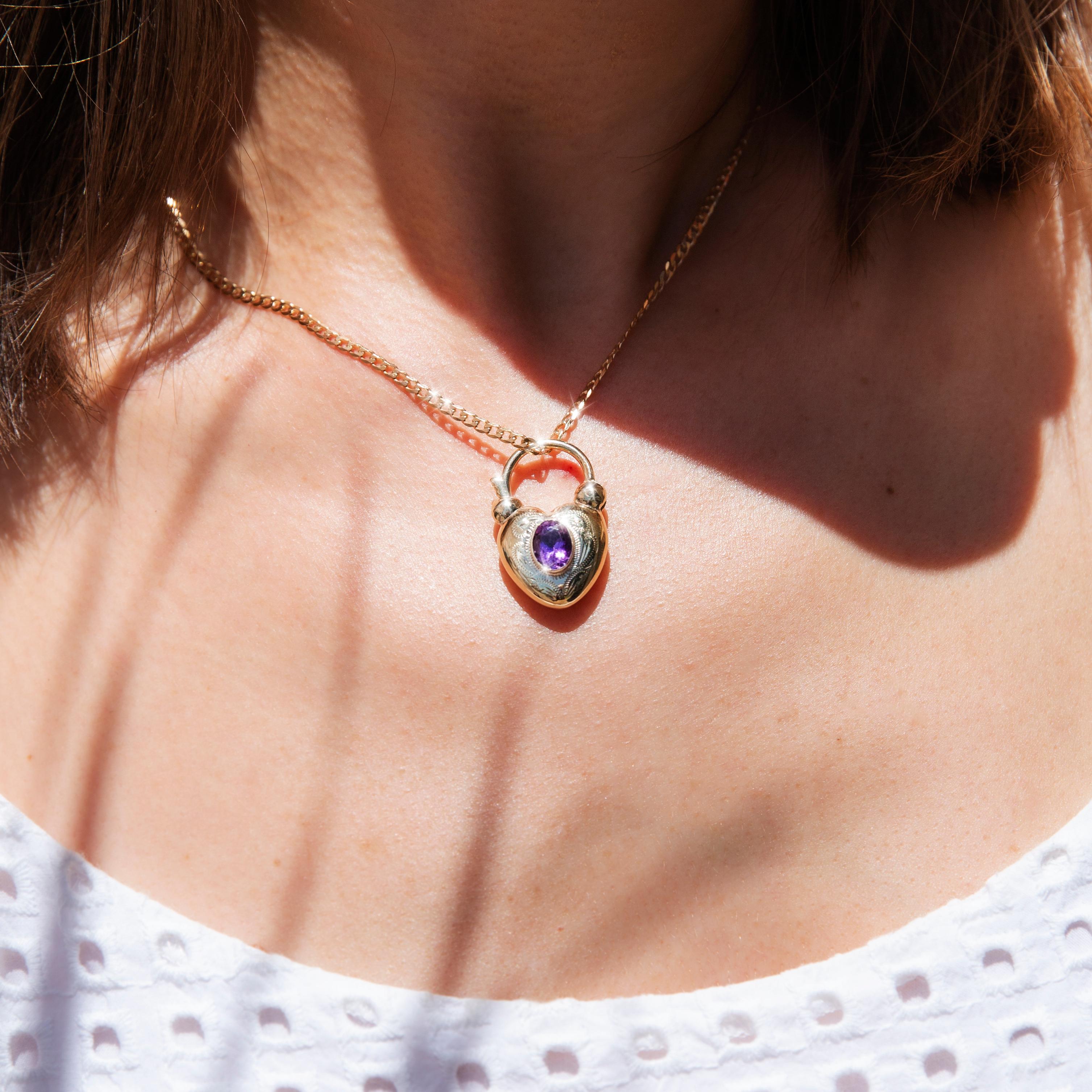 Forged in 9 carat yellow gold, this gorgeous vintage adornment, circa 1970s, is a delightful heart-shaped pendant holding an enchanting oval cut deep purple amethyst in a rubover setting. We have named this lovely vintage piece The Abbey Pendant &