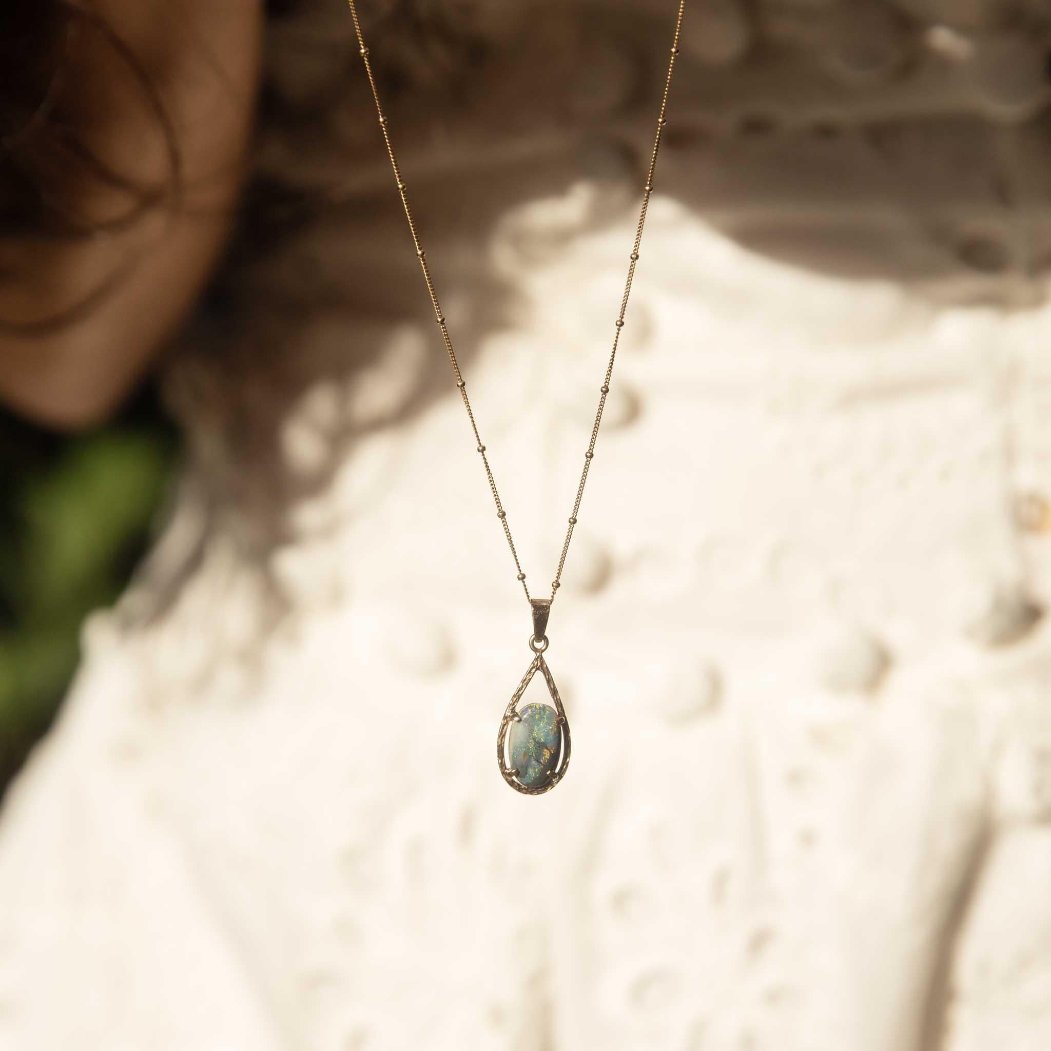 The Alannah Pendant has a river of yellow, green, blue and red that runs through the centre of her opal.  Crafted in 9 carat gold, she is framed in a patterned teardrop, a delightful vintage jewel.	

NOTE: The chain in the photos is not included.