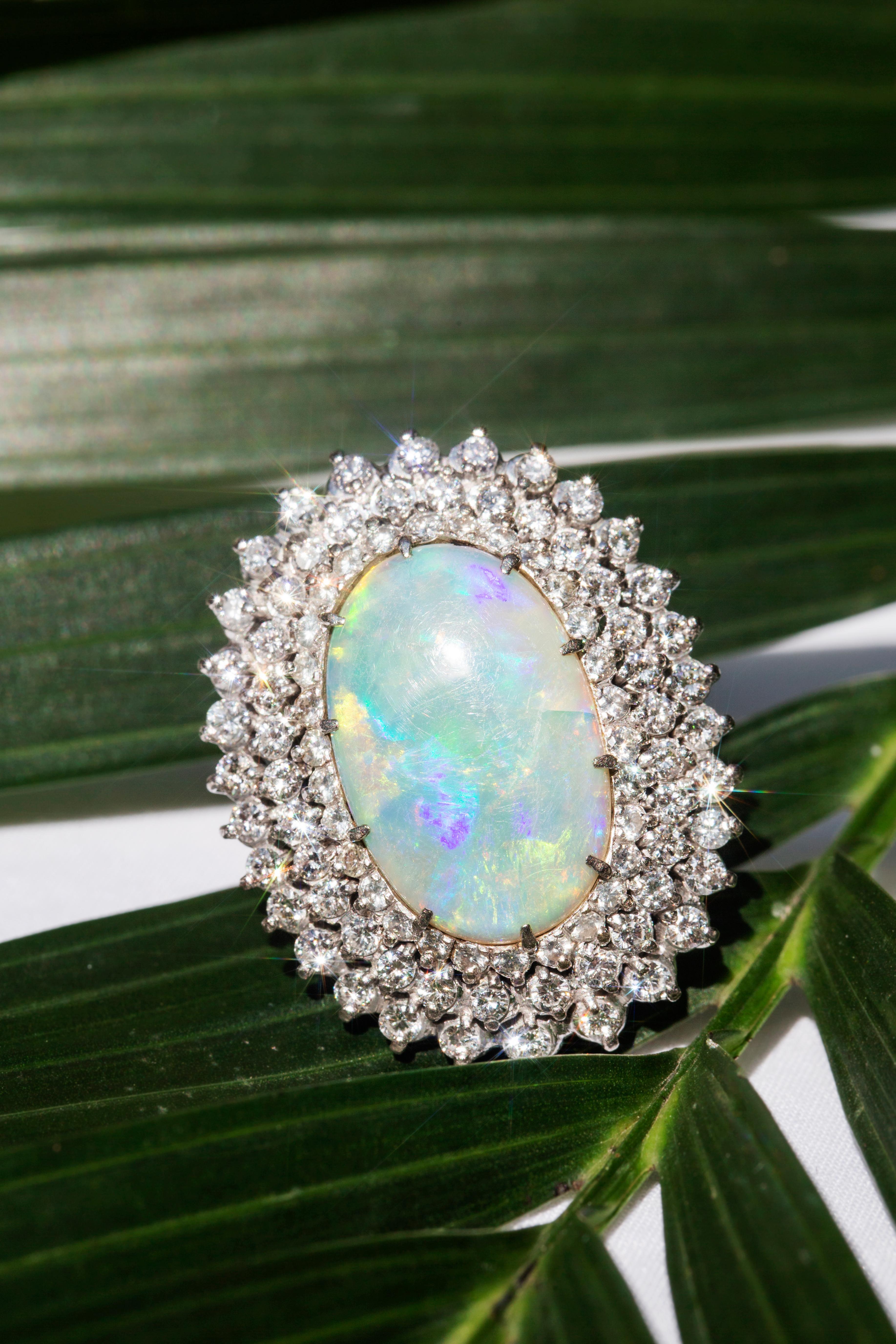 Modern Vintage Circa 1970s Australian Oval Solid Opal & Diamond Halo Ring 18 Carat Gold For Sale