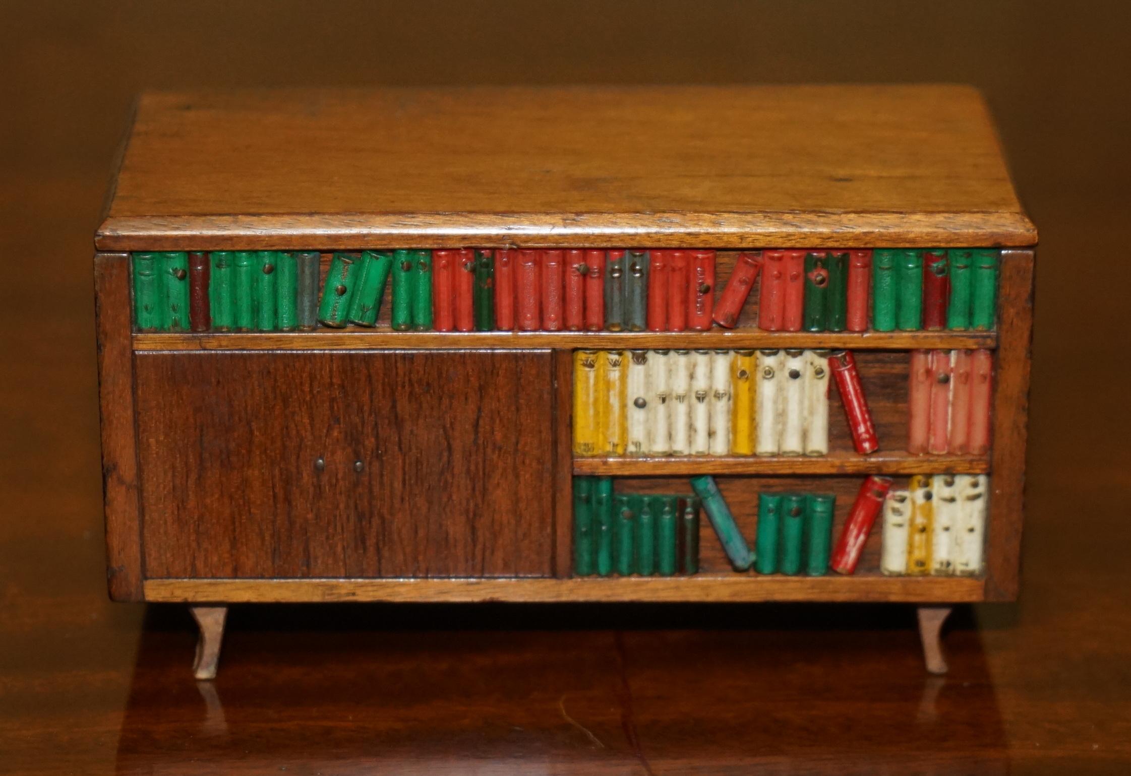Royal House Antiques

Royal House Antiques is delighted to offer for sale this lovely miniature Folk Art musical Cigarette or Cigar dispenser circa 1970’s

This is part of a small suite, I have three in total, they are a burr walnut cabinet, a