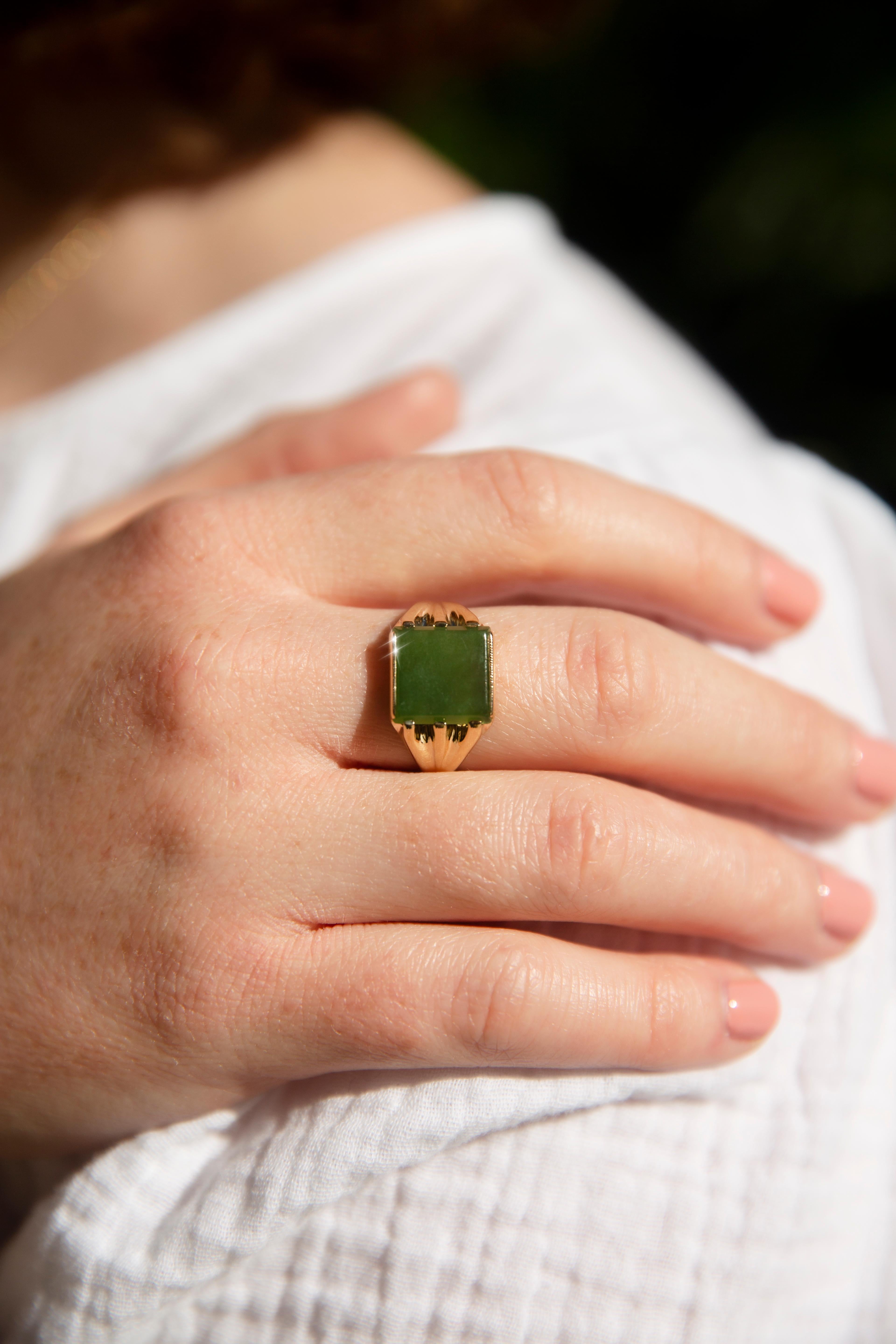 Forged in 9 carat yellow gold, this alluring vintage 1970s ring features an square-shaped nephrite jade in a partial rubover setting and claw setting on grooved shoulders. This lovely piece has been named The Sable Ring. She is the evokes strong