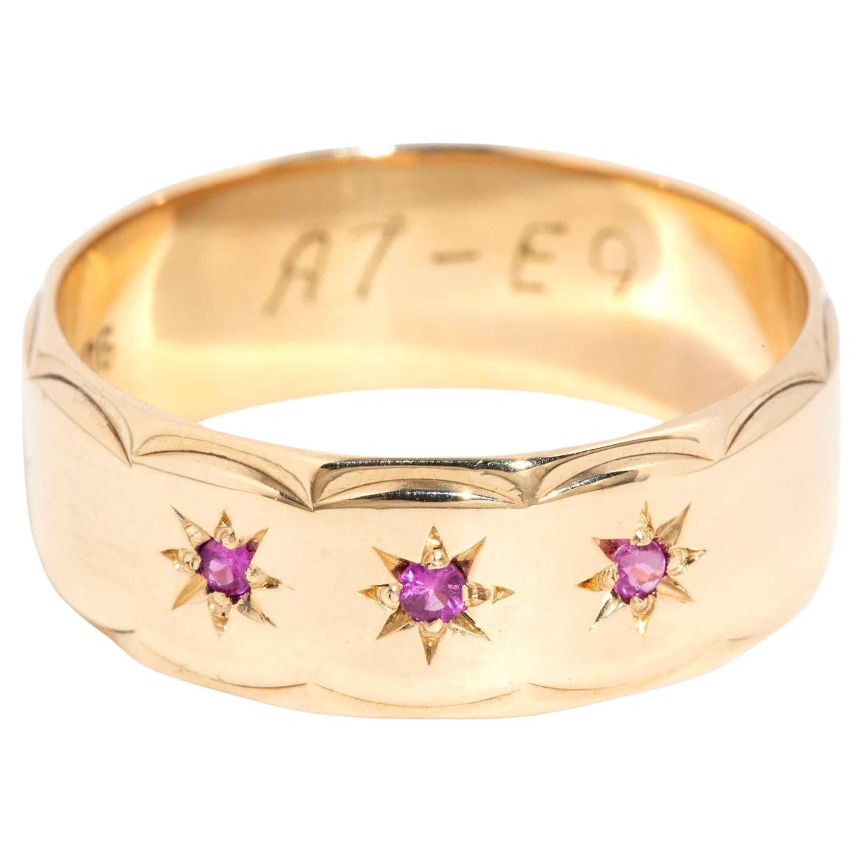 Vintage Circa 1970s Star Set Deep Pink Sapphire Trilogy Band 9 Carat Yellow Gold