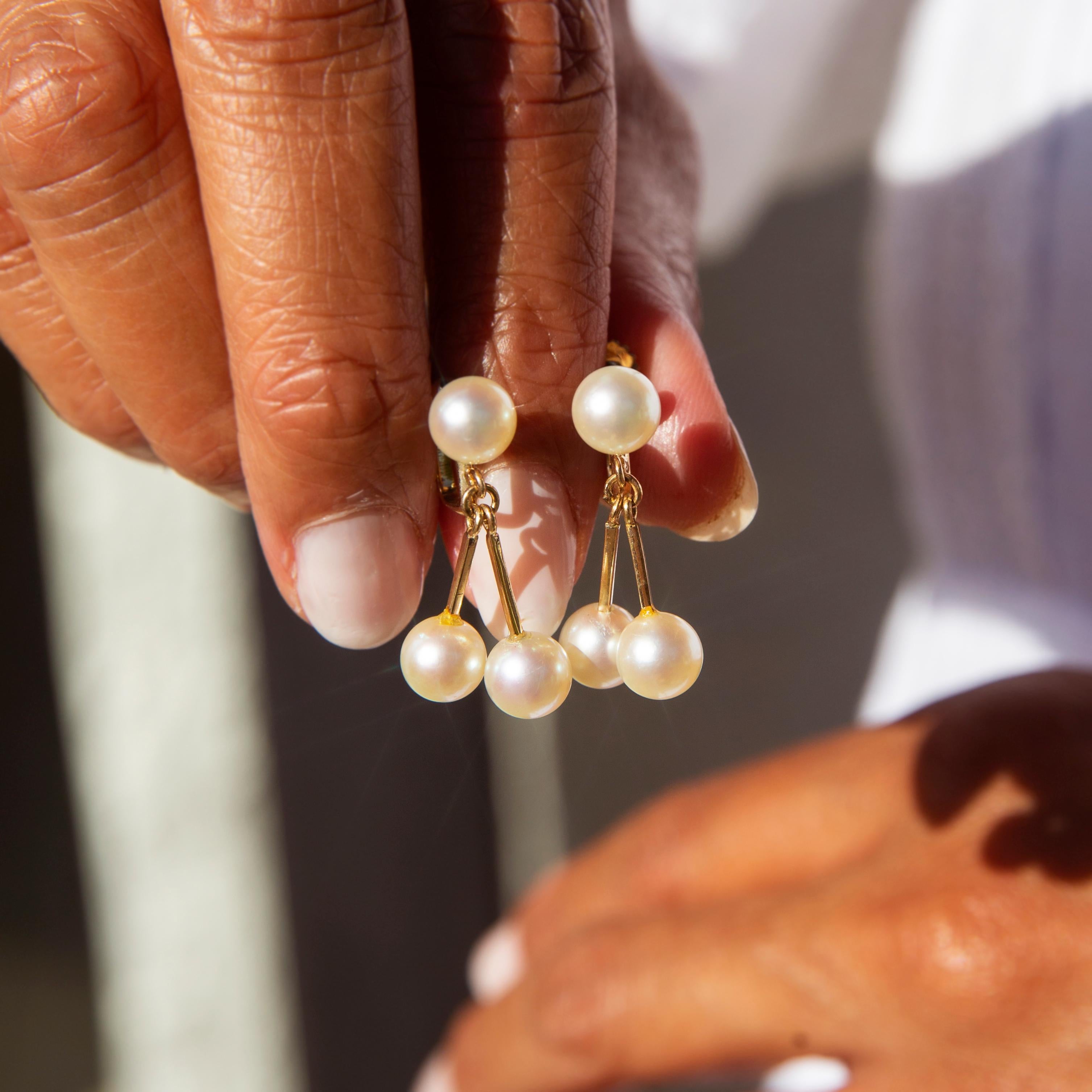 Crafted in 14 carat yellow gold, these elegant vintage clip-on earrings each feature a high luster round cultured pearl attached to a stud clip and two additional pearls suspended on gold bars. The Kiera Earrings are elegant and quietly beautiful,