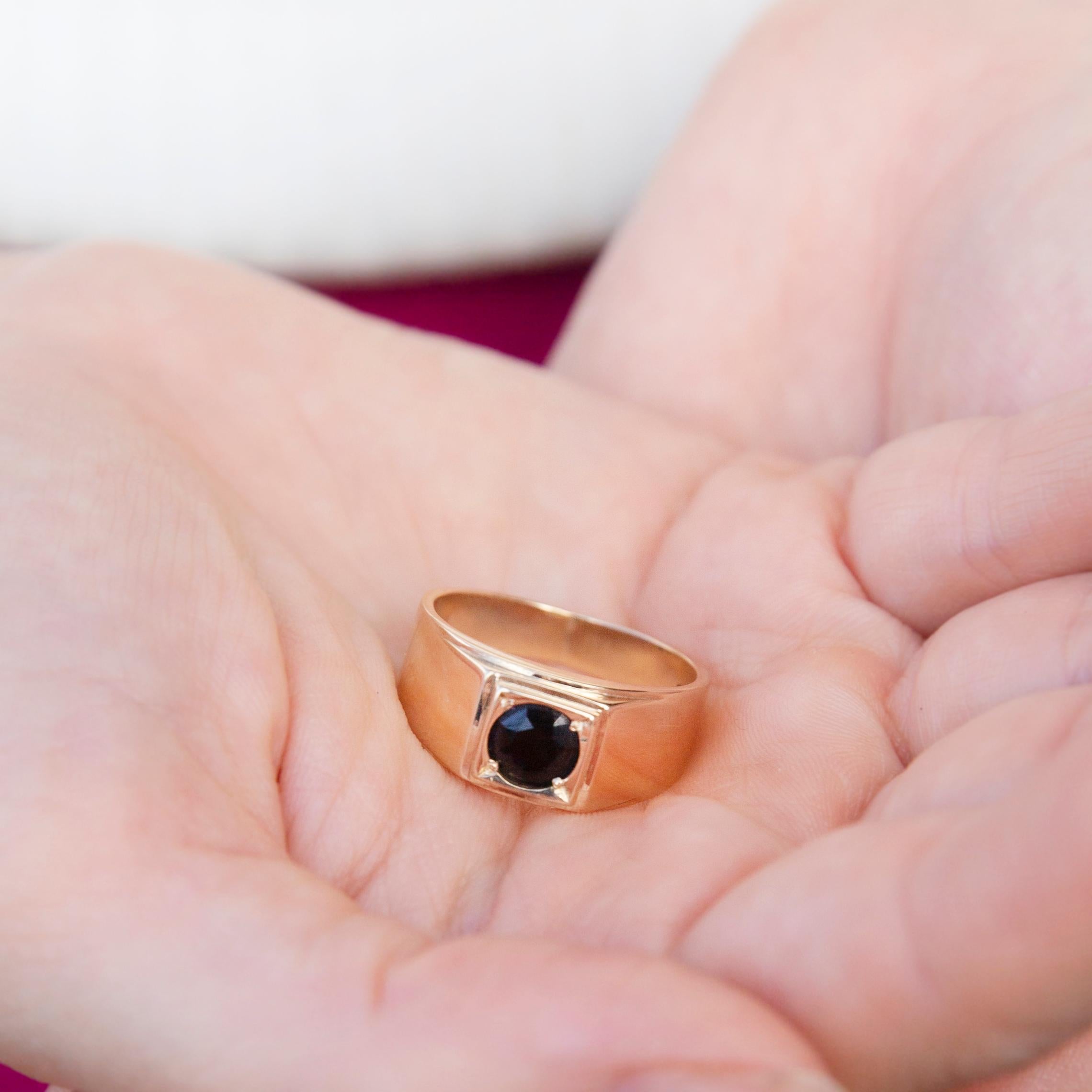 Crafted in 9 carat yellow gold, this dapper vintage men's signet ring holds a lovely dark blue natural Australian sapphire in a bezel setting. This sleek ring has been named The Noctis Ring. The high polish band and sapphire look incredibly