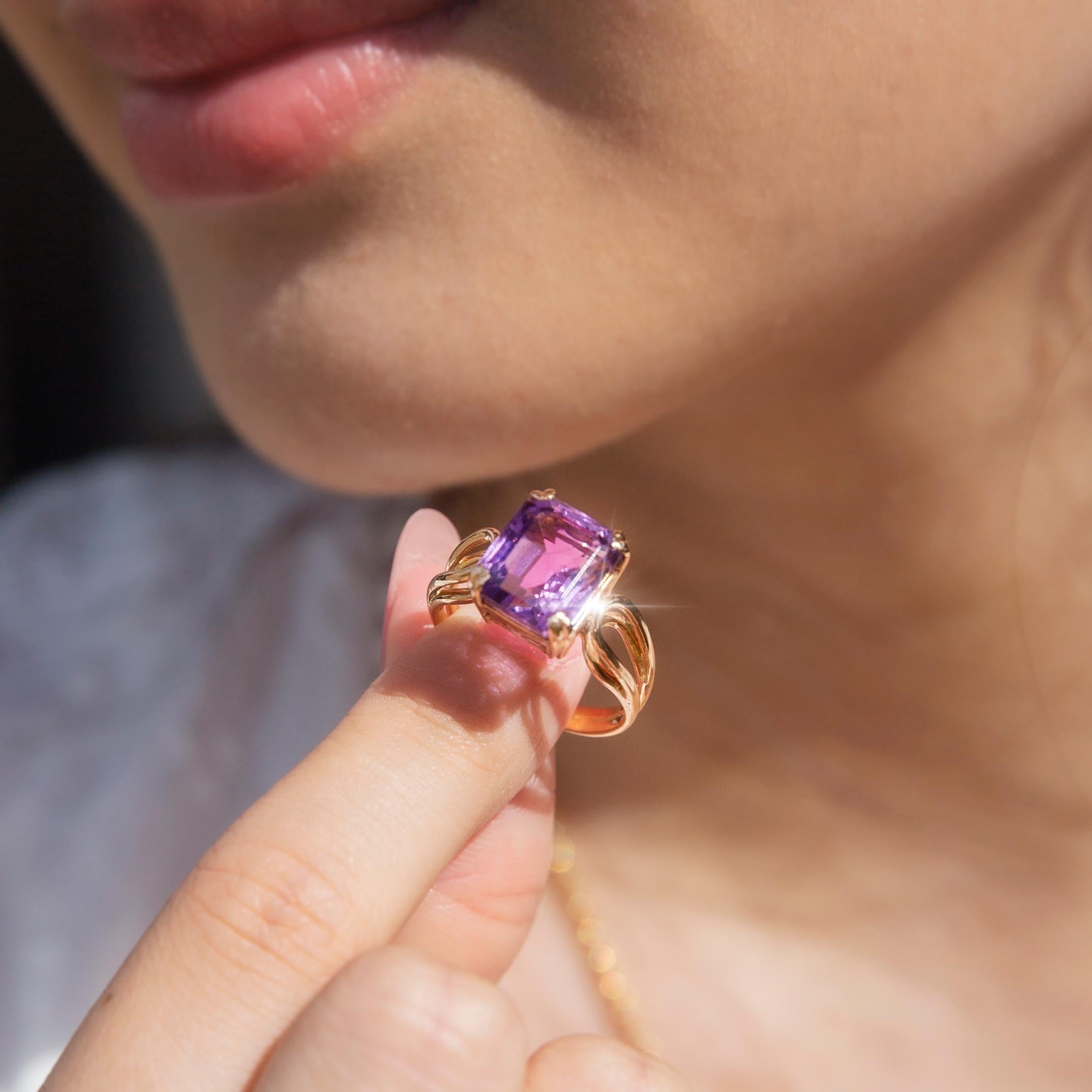Forged in 18 carat gold, this darling vintage ring features a lovely 4.91 carat faceted emerald cut amethyst set atop elegant wire frame shoulders. This lovely vintage piece has been named The Laia Ring. Her captivating amethyst is seated just high