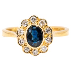 Vintage Circa 1980s 18 Carat Yellow Gold Sapphire and Diamond Halo Cluster Ring