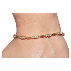 Vintage Circa 1980 Bracelet de tennis en or 18k orné de diamants naturels