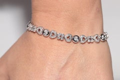 Vintage Circa 1980 Bracelet de tennis en or 18k orné de diamants naturels