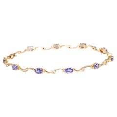 Vintage Circa 1980s 9 Carat Yellow Gold Oval Tanzanite and Diamond Link Bracelet