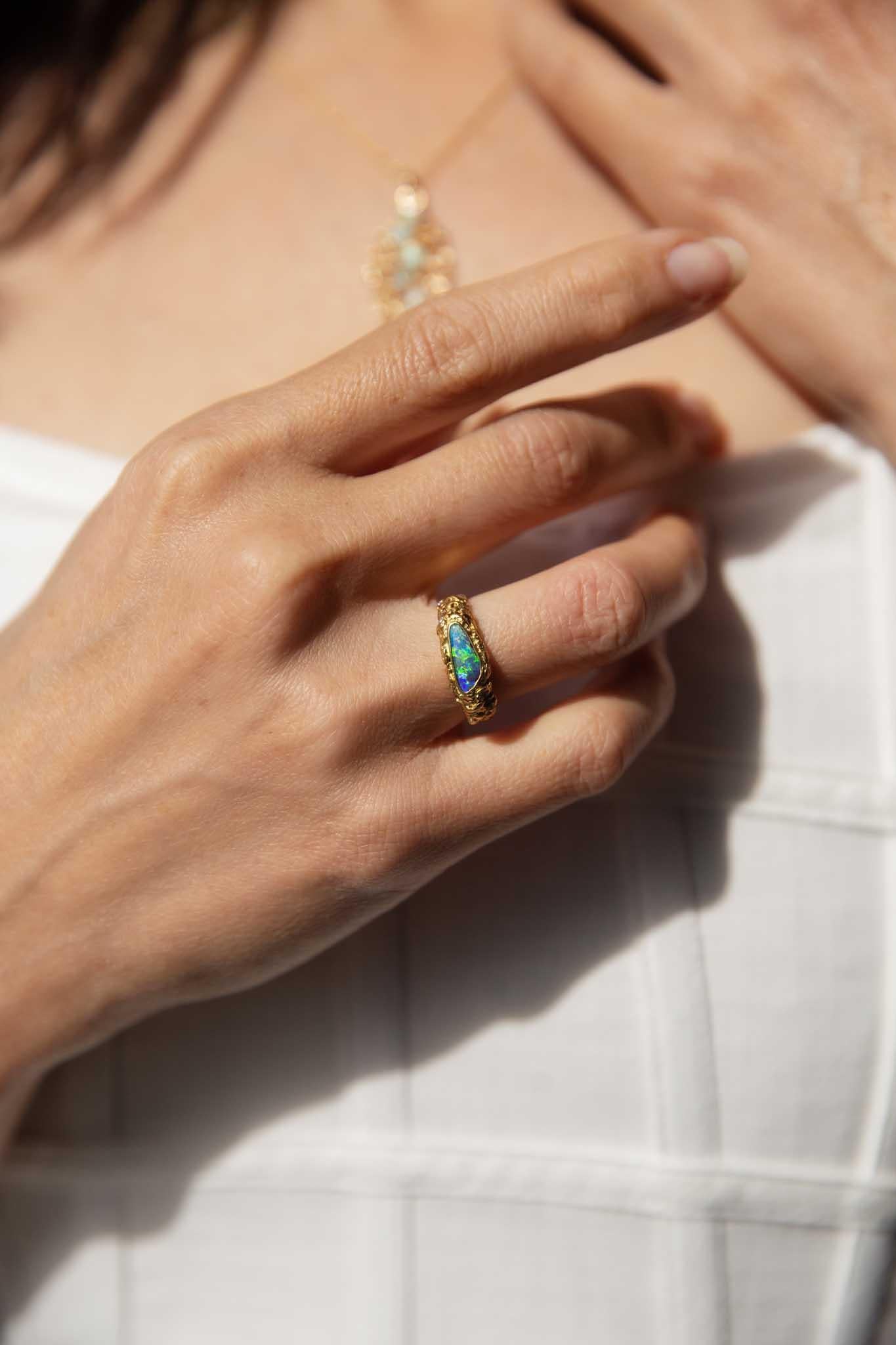From the heart of the Australian Outback comes our Nadia Ring. Her opal flashes vivid blue, green, and red, resplendent against diamond-accented gold that retains its natural elegance. Inspired by nature’s whimsy, she is a breathtaking piece,