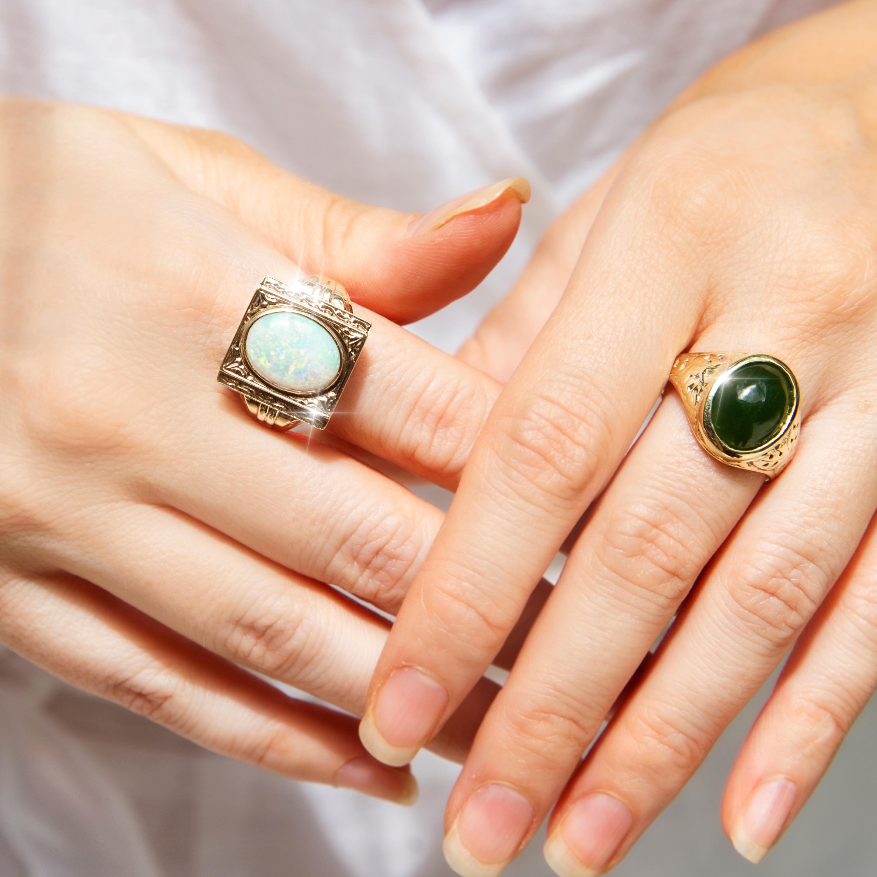 Forged in 14 carat yellow gold, this gorgeous vintage ring, circa 1980s, features an opulent deep green Nephrite jade cabochon set on patterned domed shoulders. This lovely adornment has been named The Logan Ring. She is a graceful everyday ring