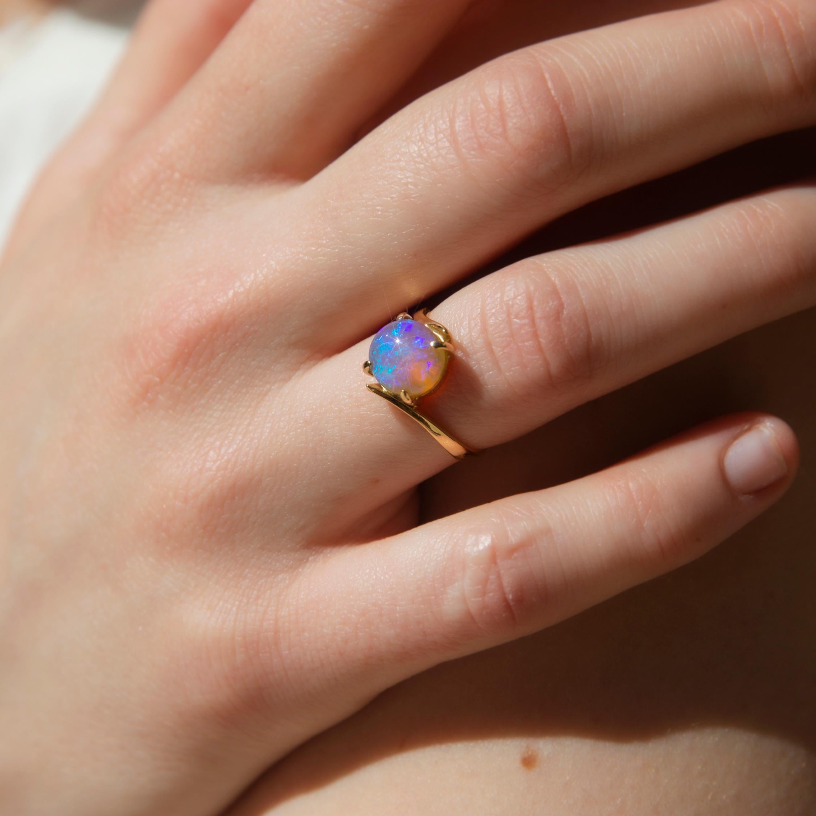 Crafted in 18 carat gold, The Monique Ring curves gently around the crystal opal, raising it into the light and radiating soft hues of green and red. From the earth of the outback she brings such ethereal beauty.  

The Monique Ring Gem Details
The