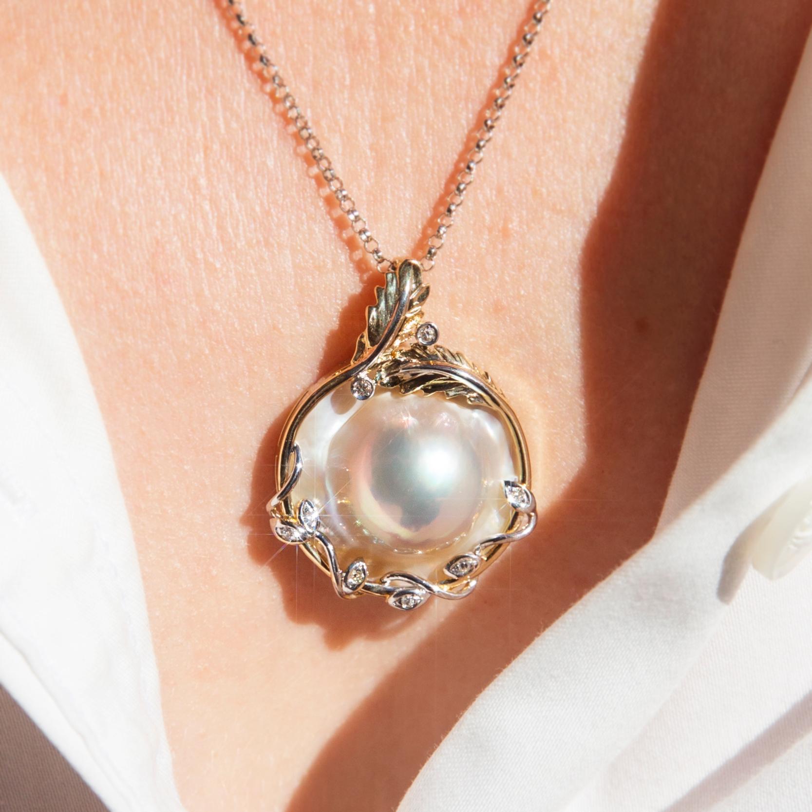 Crafted in 10 carat yellow and white gold, this darling leaf-like pendant features a gorgeous mabe pearl set into an elegant twisted frame set with round brilliant cut diamonds and finished with a white gold chain. Her name is The Vivienne Pendant &