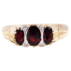 Vintage Circa 1990s 9 Carat Yellow Gold Oval Garnet and Diamond Cluster Ring